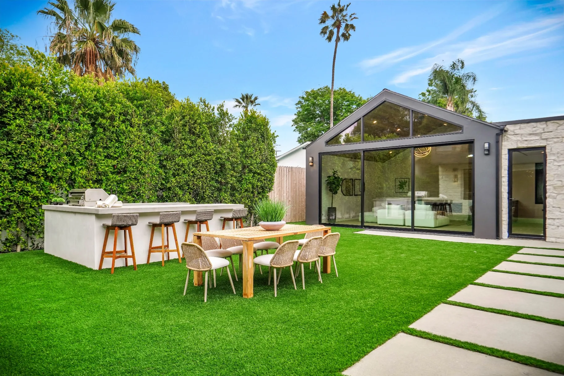 15602 Morrison St — Backyard: Outdoor entertainment area with dining space and modern landscape design