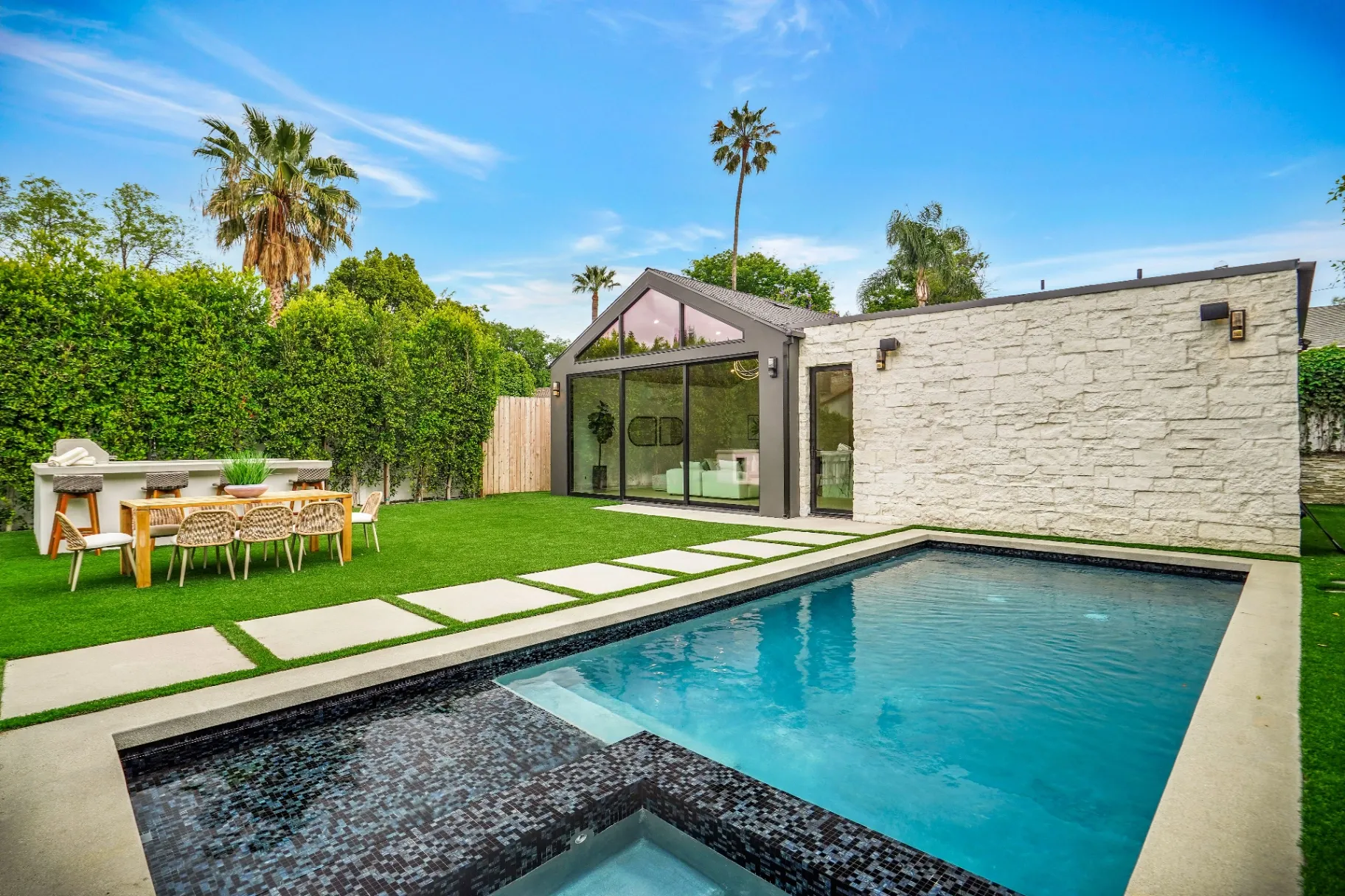 15602 Morrison St — Backyard: Pool and spa with artificial turf, outdoor bar, and contemporary outdoor furniture