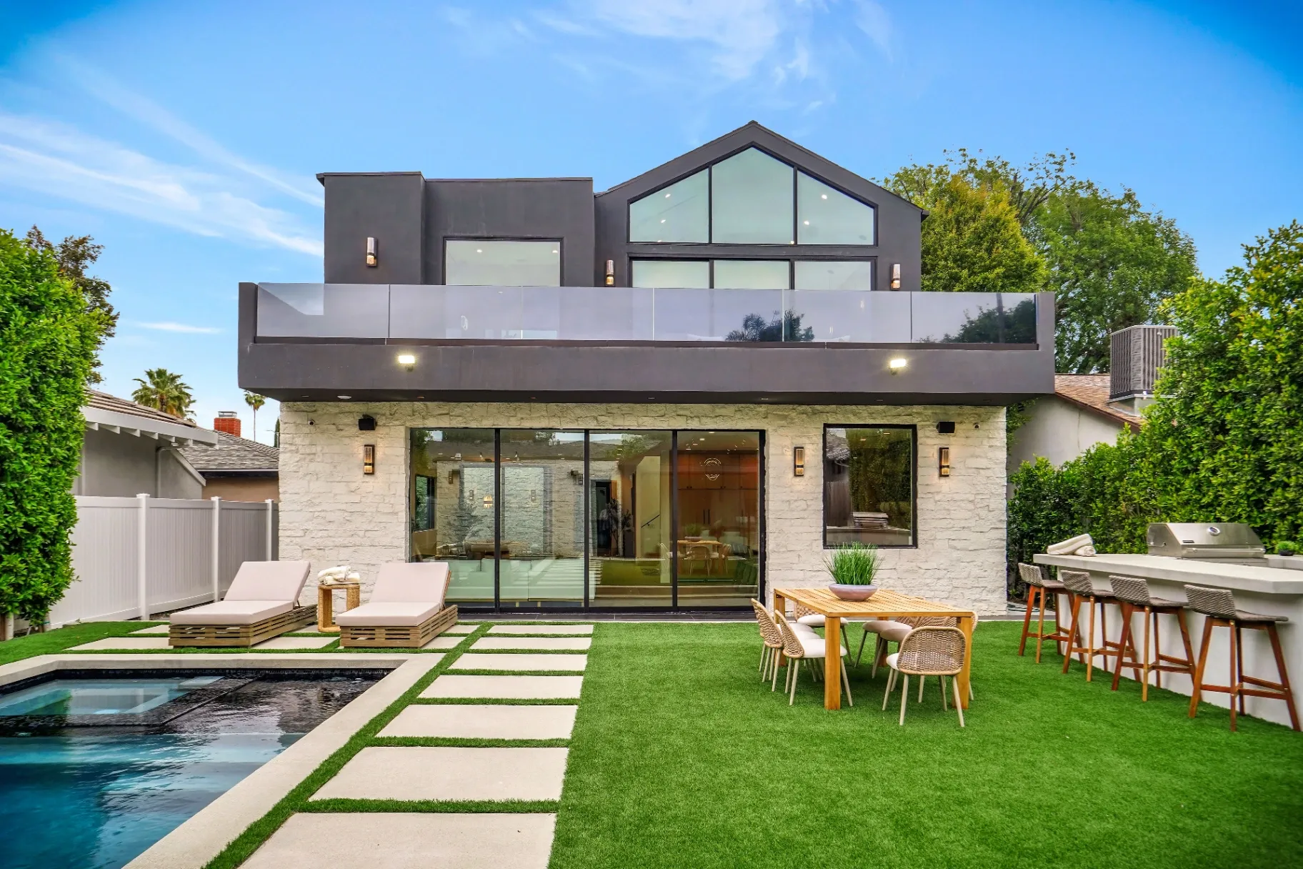 15602 Morrison St — Backyard: Contemporary outdoor living space with pool, modern architecture, and entertainment areas