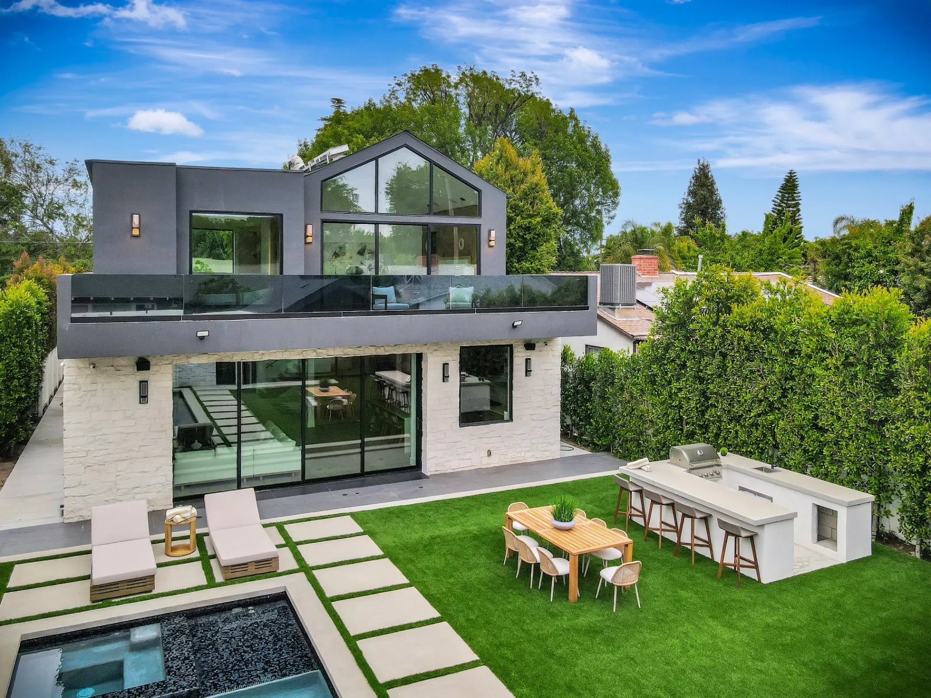 15602 Morrison St — Backyard: 15602 Morrison St — Aerial view of modern home with rectangular pool, artificial grass, and outdoor entertainment areas