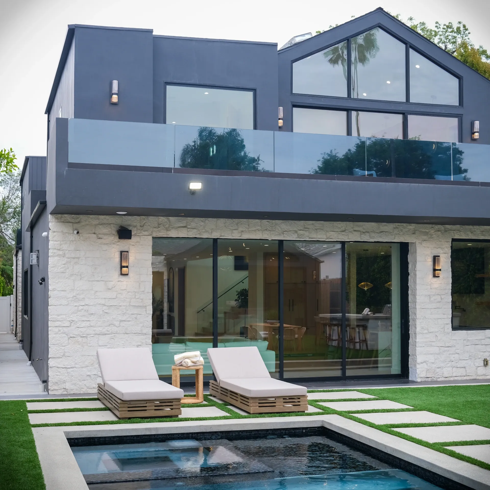 15602 Morrison St — Backyard: 15602 Morrison St — Contemporary home exterior with glass railings, pool area, and modern outdoor furniture