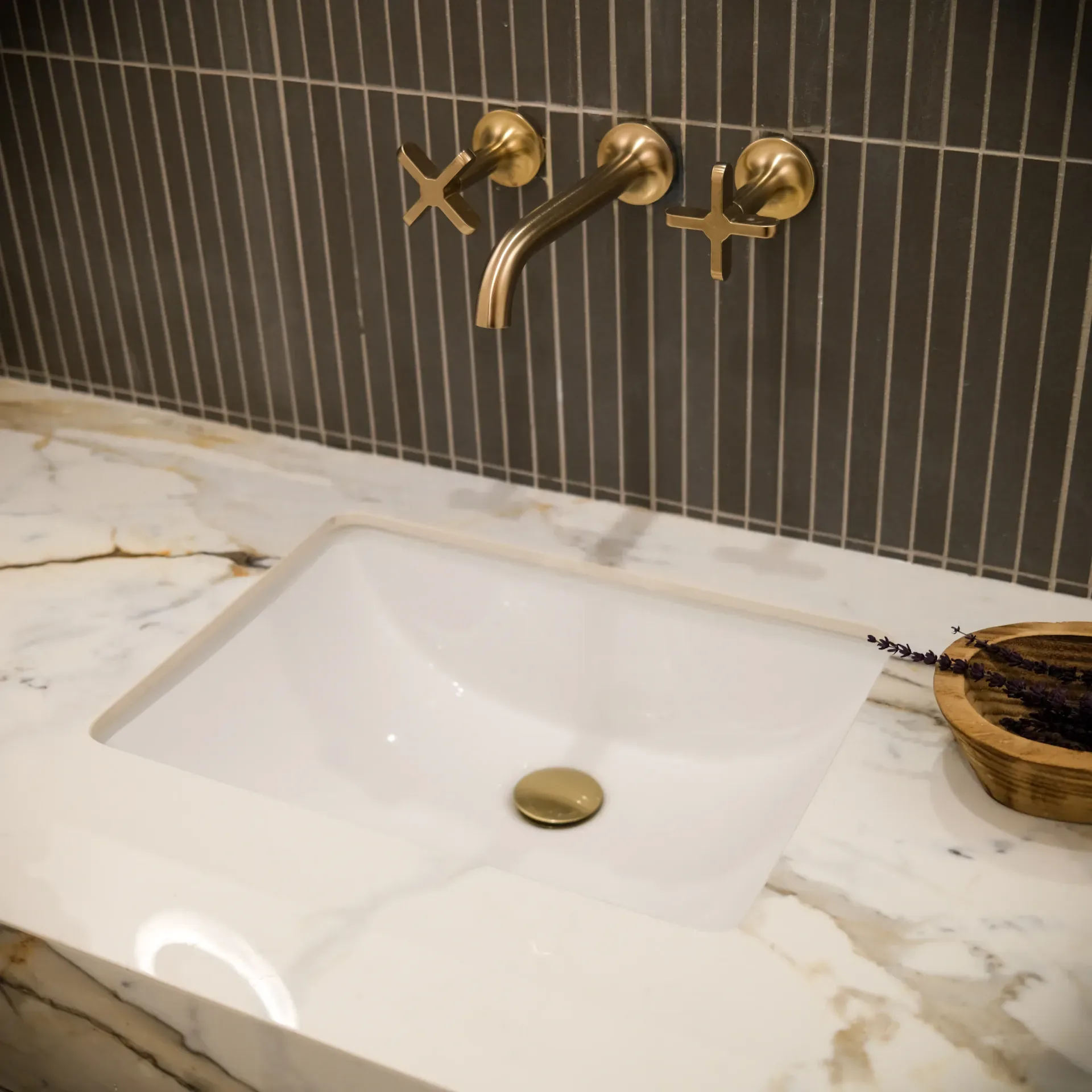 15602 Morrison St — Bathrooms: 15602 Morrison St — Bathroom vanity detail with brass wall-mounted faucets, fluted tile backsplash, and marble countertops