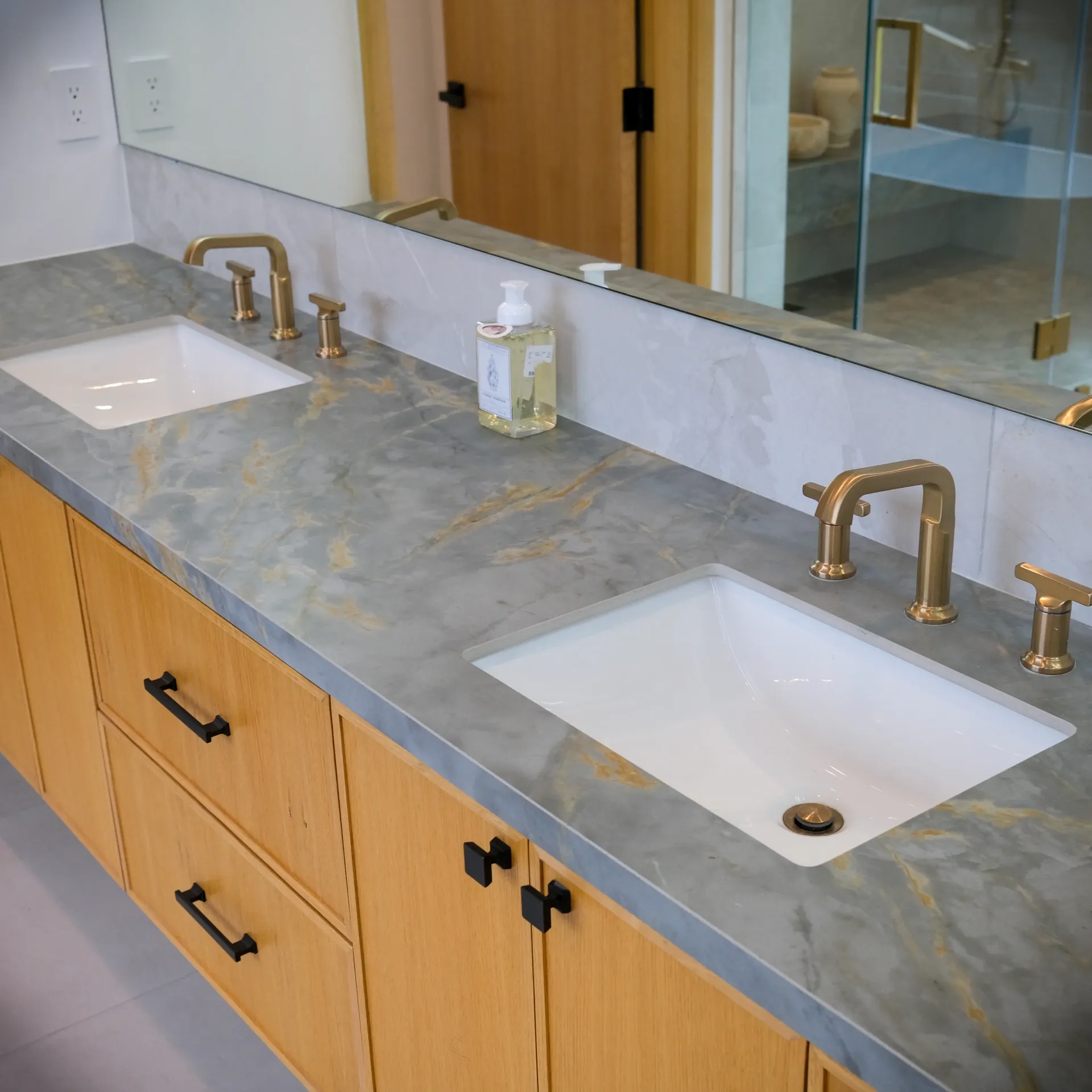 15602 Morrison St — Bathrooms: 15602 Morrison St — Double vanity with wood cabinetry, gray marble countertops, and brass fixtures