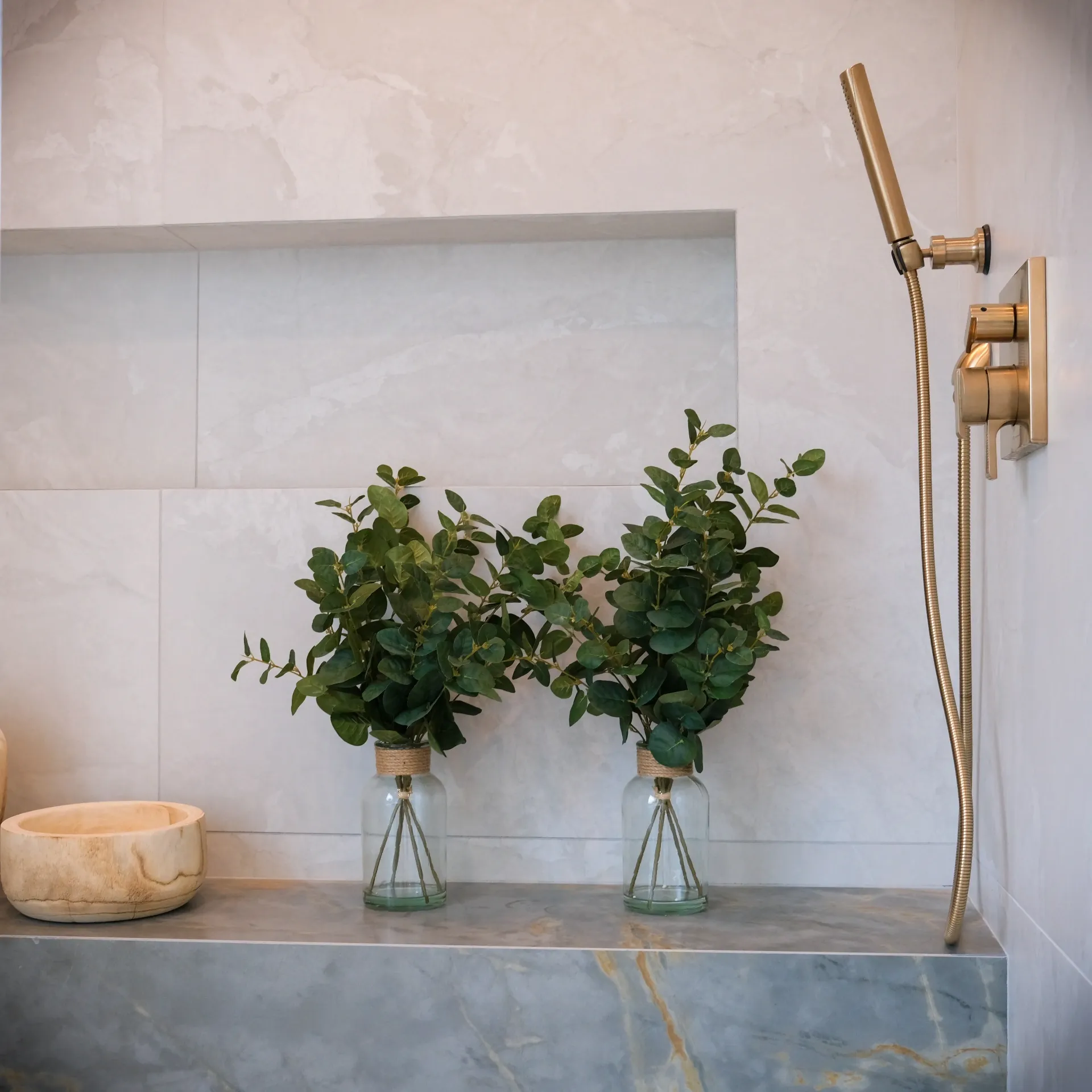 15602 Morrison St — Bathrooms: 15602 Morrison St — Shower bench detail with marble seating, built-in storage niche, and brass handheld shower