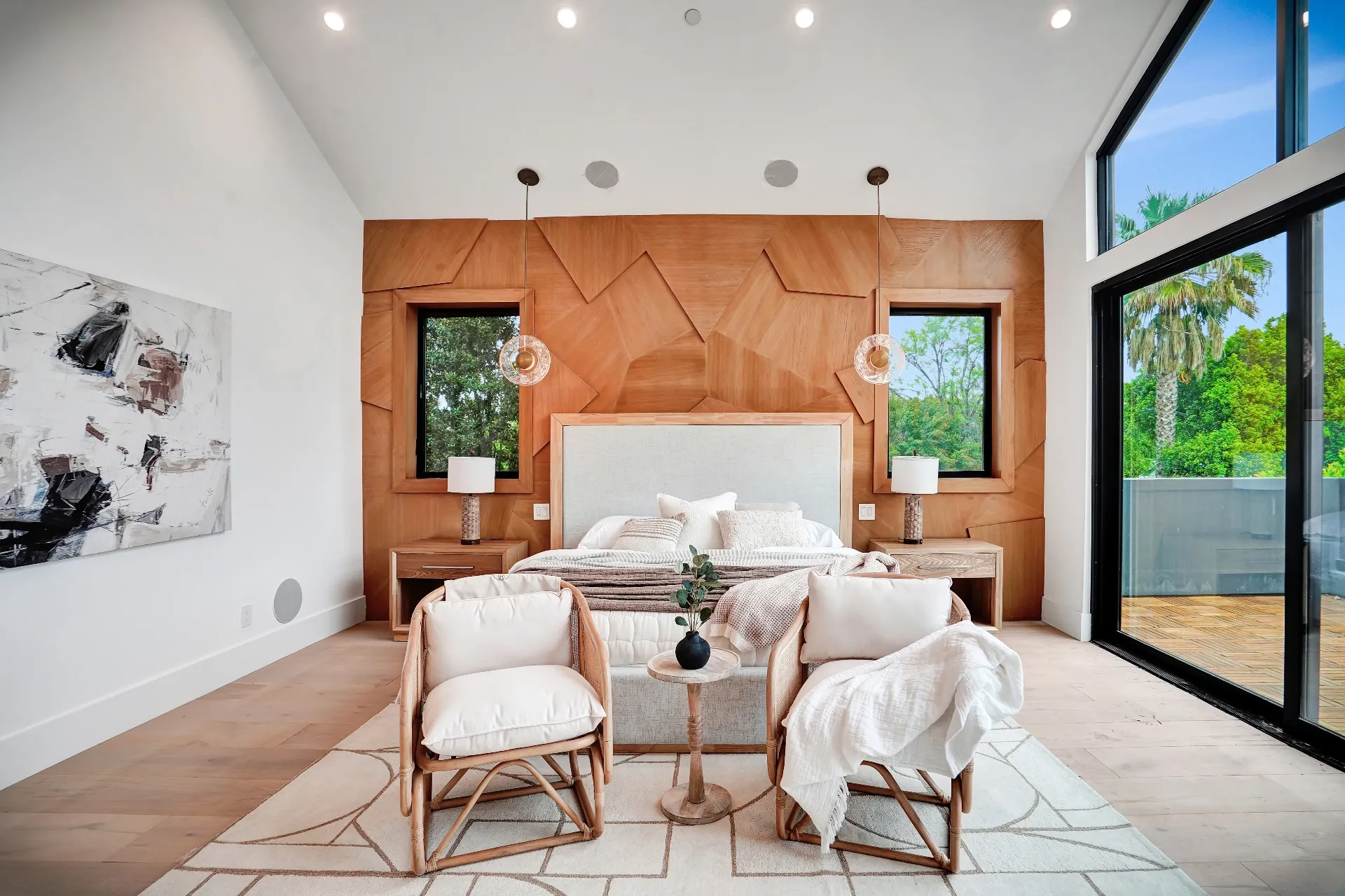 15602 Morrison St — Bedrooms: 15602 Morrison St — Master bedroom featuring geometric wood headboard wall, white and beige bedding, and large sliding glass doors