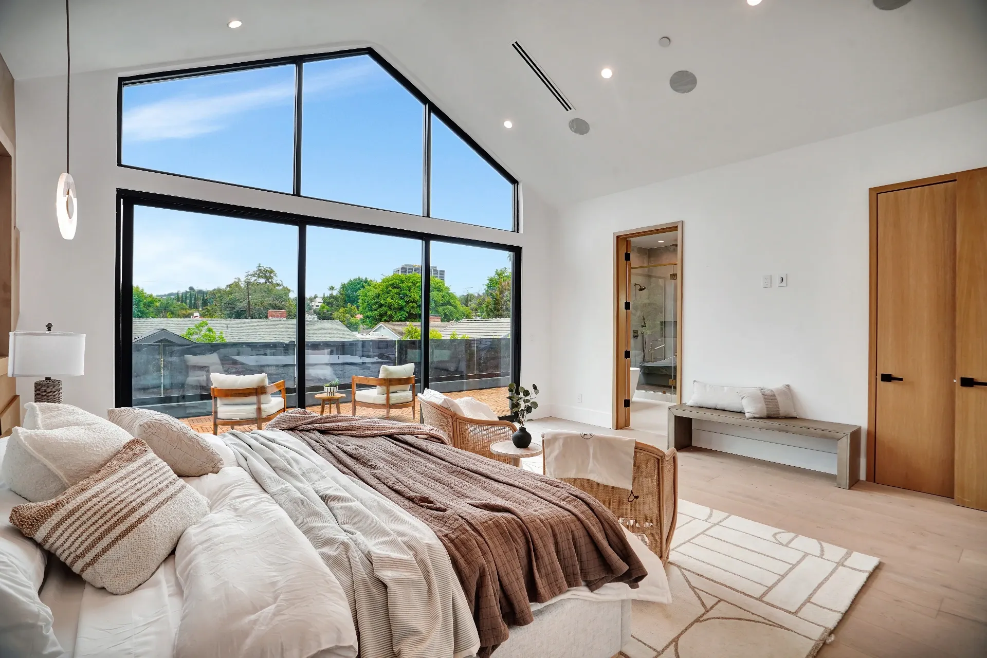 15602 Morrison St — Bedrooms: 15602 Morrison St — Primary suite with vaulted ceiling, glass windows, built-in bench seating, and ensuite bathroom access