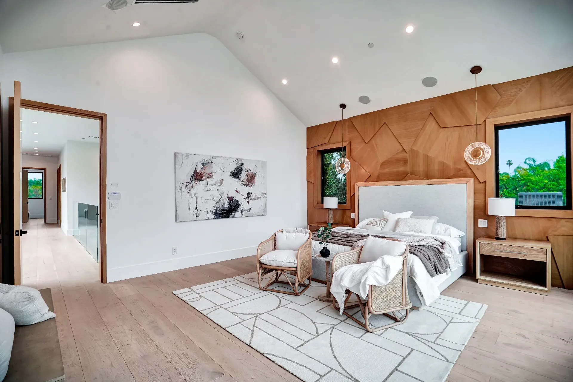 15602 Morrison St — Bedrooms: 15602 Morrison St — Master bedroom with geometric wood accent wall, neutral bedding, and abstract artwork