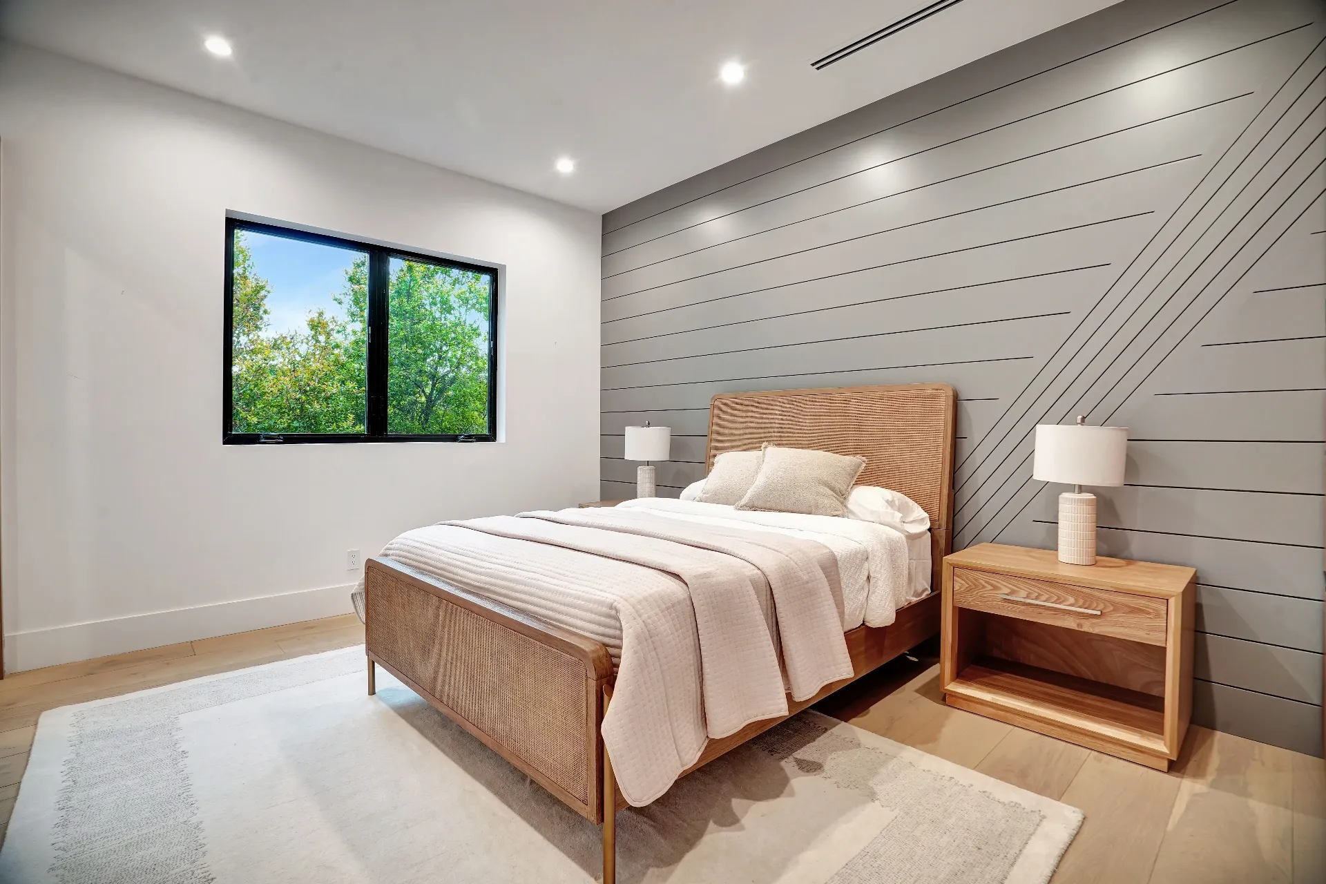 15602 Morrison St — Bedrooms: 15602 Morrison St — Bedroom with horizontal wood slat accent wall, rattan headboard, neutral textiles, and modern nightstands