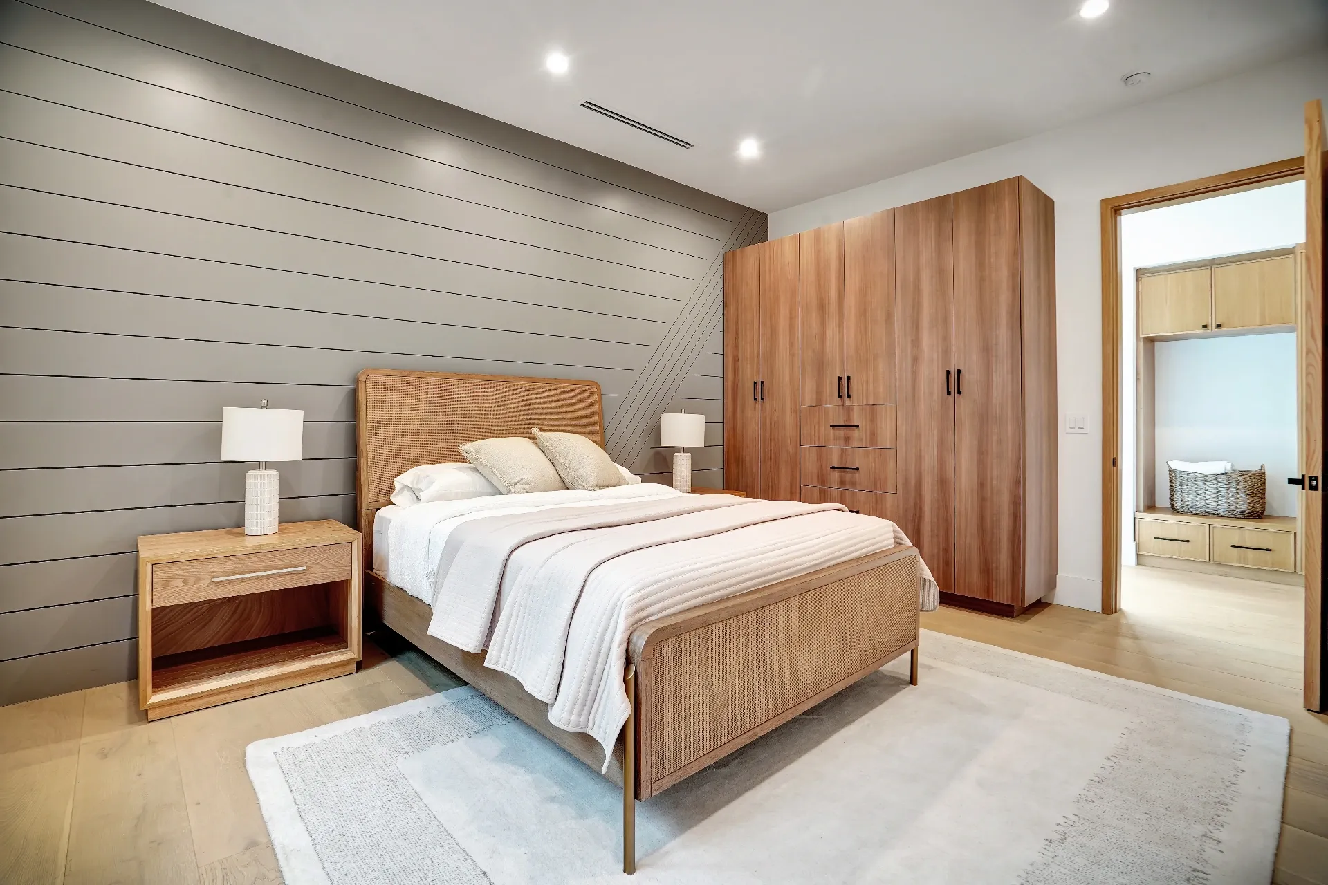 15602 Morrison St — Bedrooms: 15602 Morrison St — Contemporary bedroom featuring horizontal wood slat wall, rattan bed, and wood built-in wardrobes