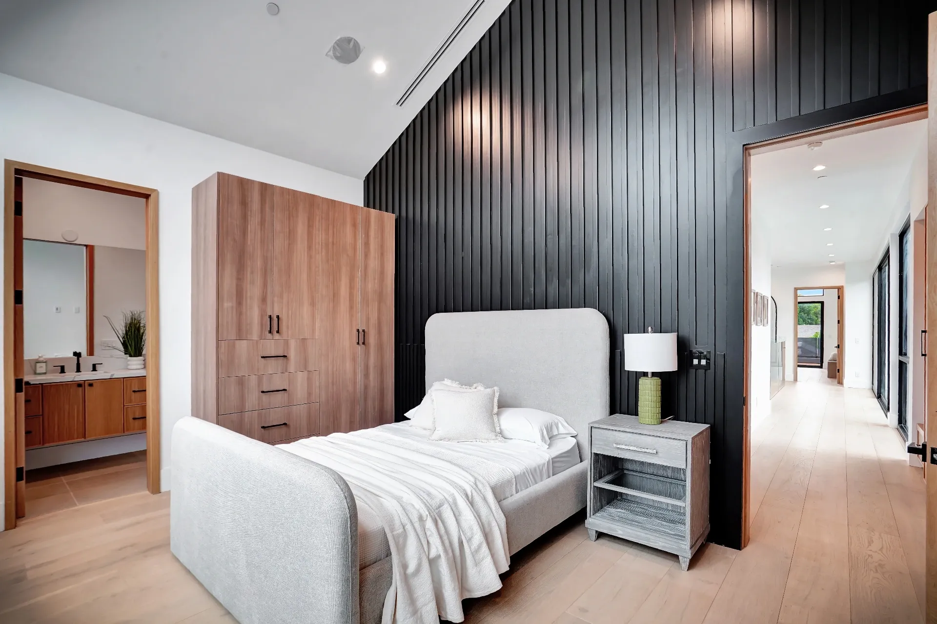 15602 Morrison St — Bedrooms: 15602 Morrison St — Modern bedroom with dark vertical slat accent wall, upholstered headboard, and built-in wood cabinetry