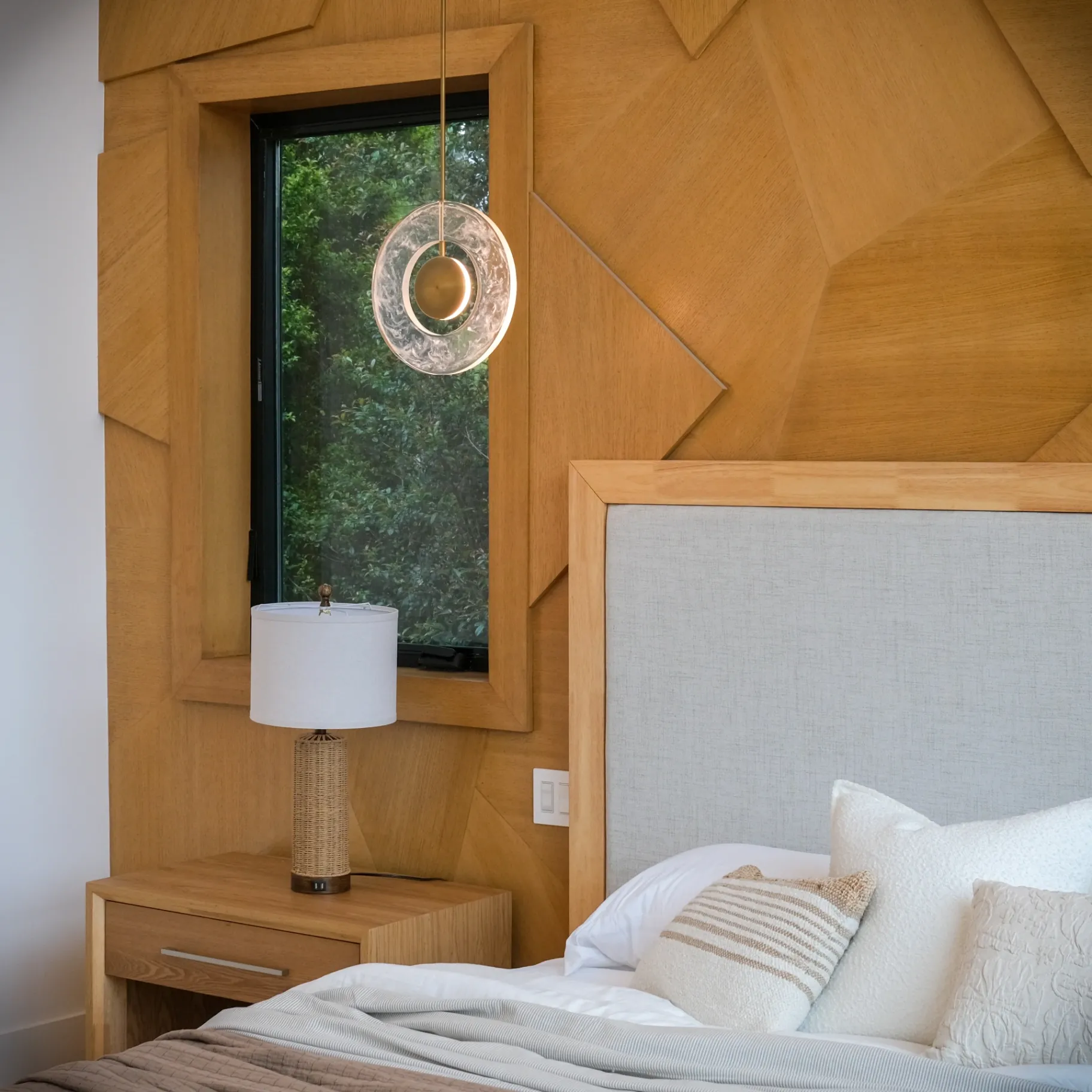 15602 Morrison St — Bedrooms: 15602 Morrison St — Master bedroom with geometric wood feature wall, floating nightstand, and modern table lamp