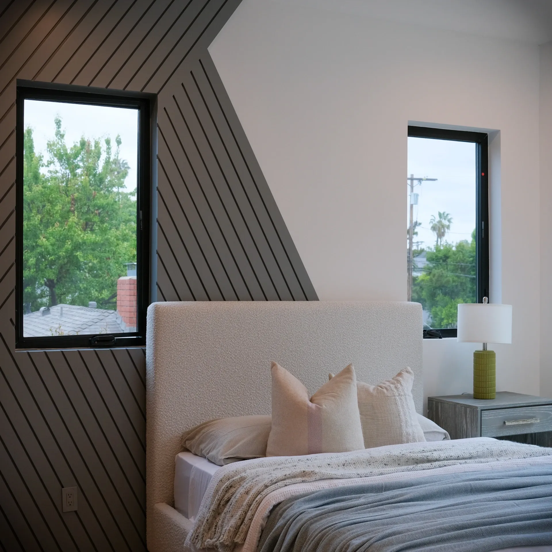 15602 Morrison St — Bedrooms: 15602 Morrison St — Bedroom with diagonal wood slat accent wall, upholstered platform bed, and modern nightstand