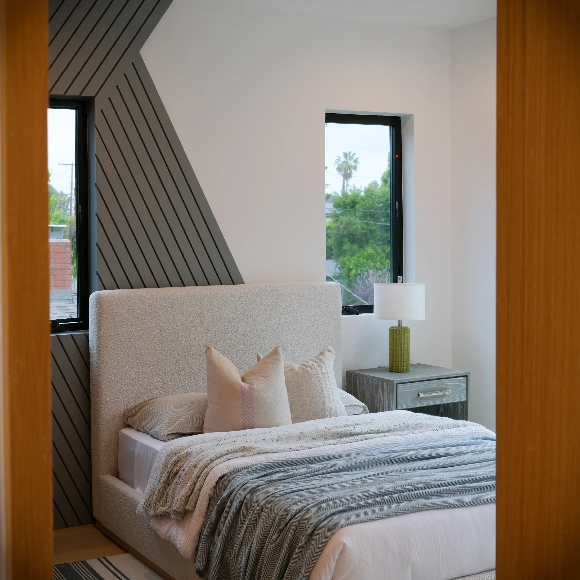 15602 Morrison St — Bedrooms: 15602 Morrison St — Bedroom detail with diagonal wood accent wall, upholstered headboard, and city views