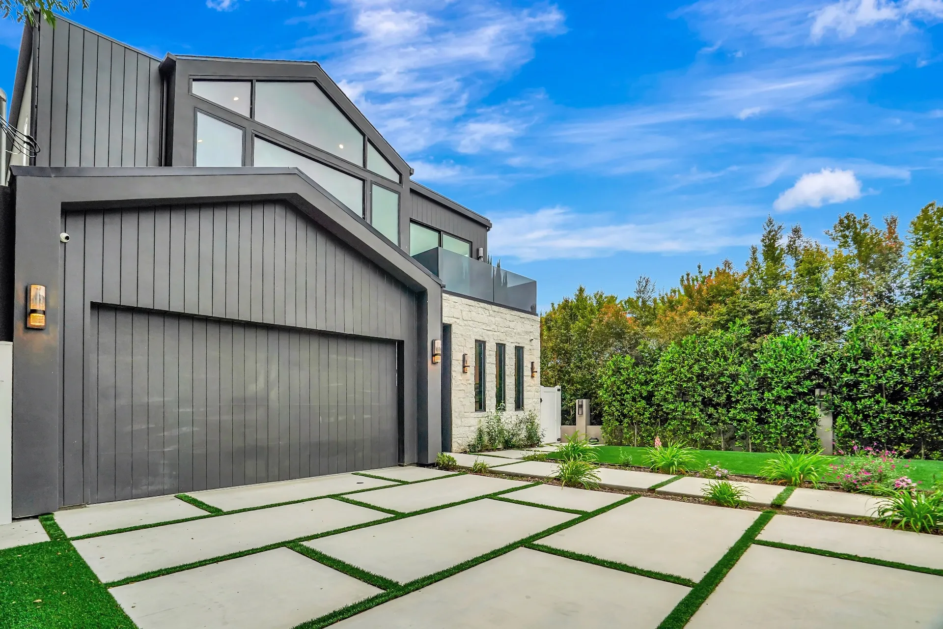 15602 Morrison St — Exterior: 15602 Morrison St — Modern home exterior with geometric concrete driveway, artificial grass landscaping, and two-story glass windows