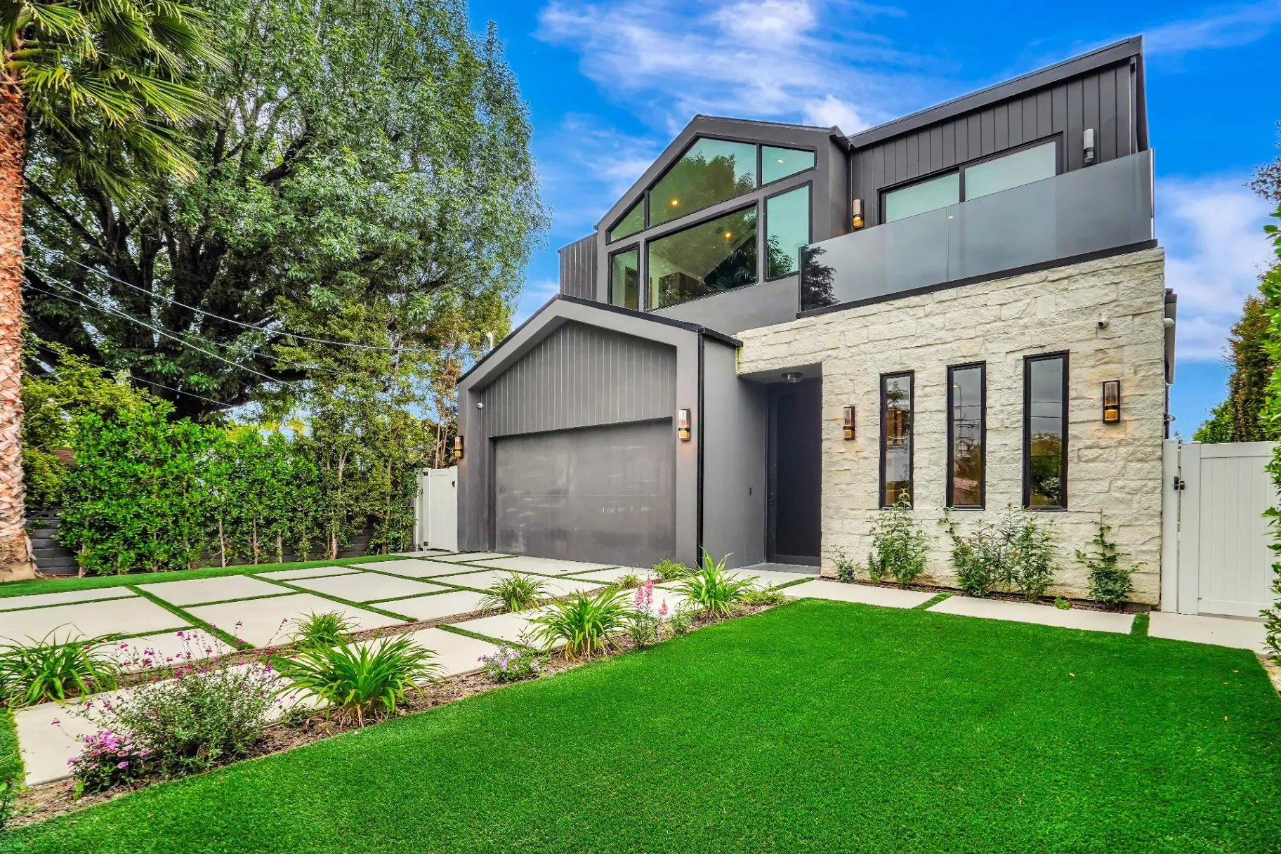 15602 Morrison St — Exterior: 15602 Morrison St — Contemporary exterior showcasing dark siding, white stone walls, and beautifully designed front landscaping