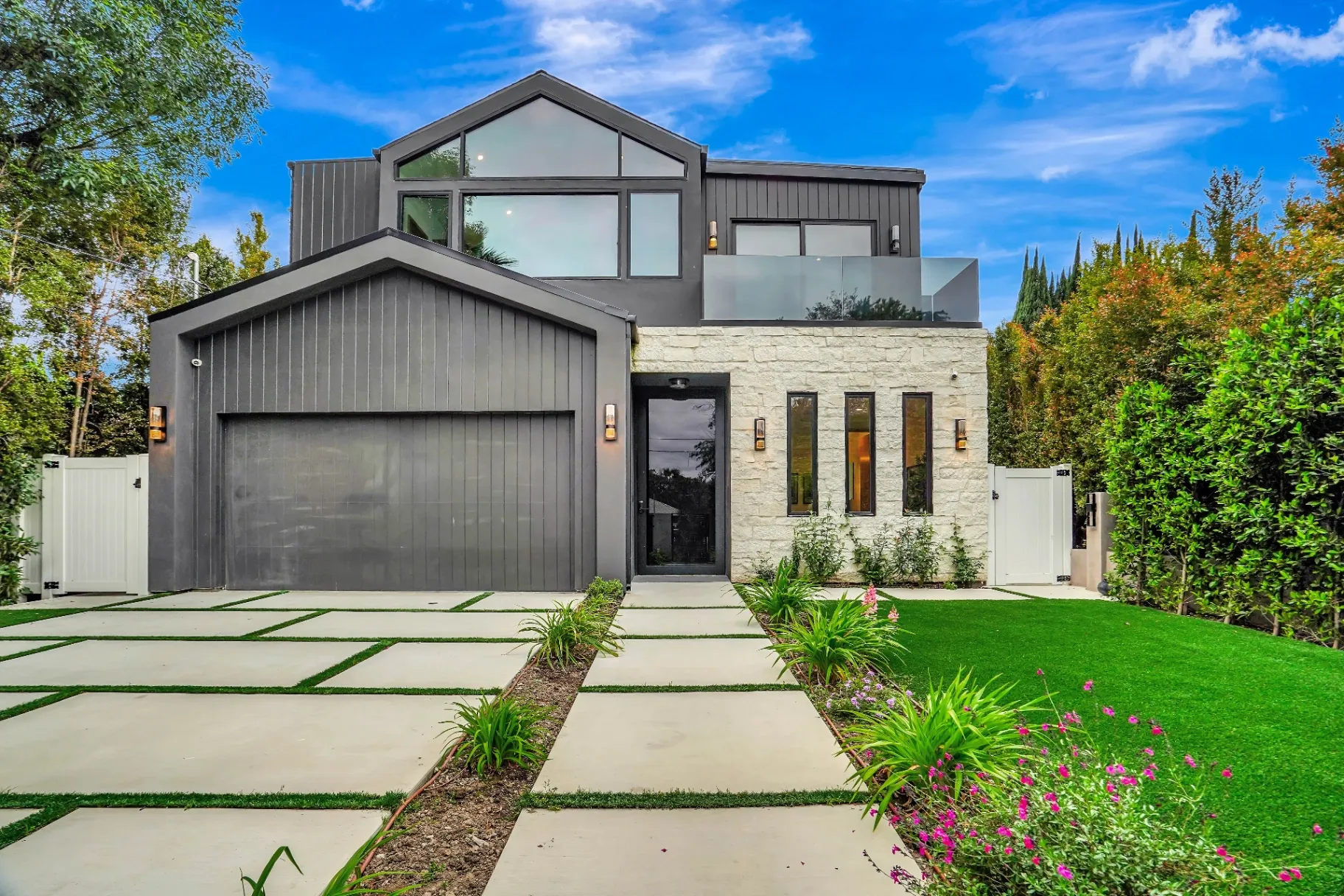 15602 Morrison St — Exterior: 15602 Morrison St — Modern home entrance with horizontal-slat fencing, artificial turf, and concrete walkway leading to front door
