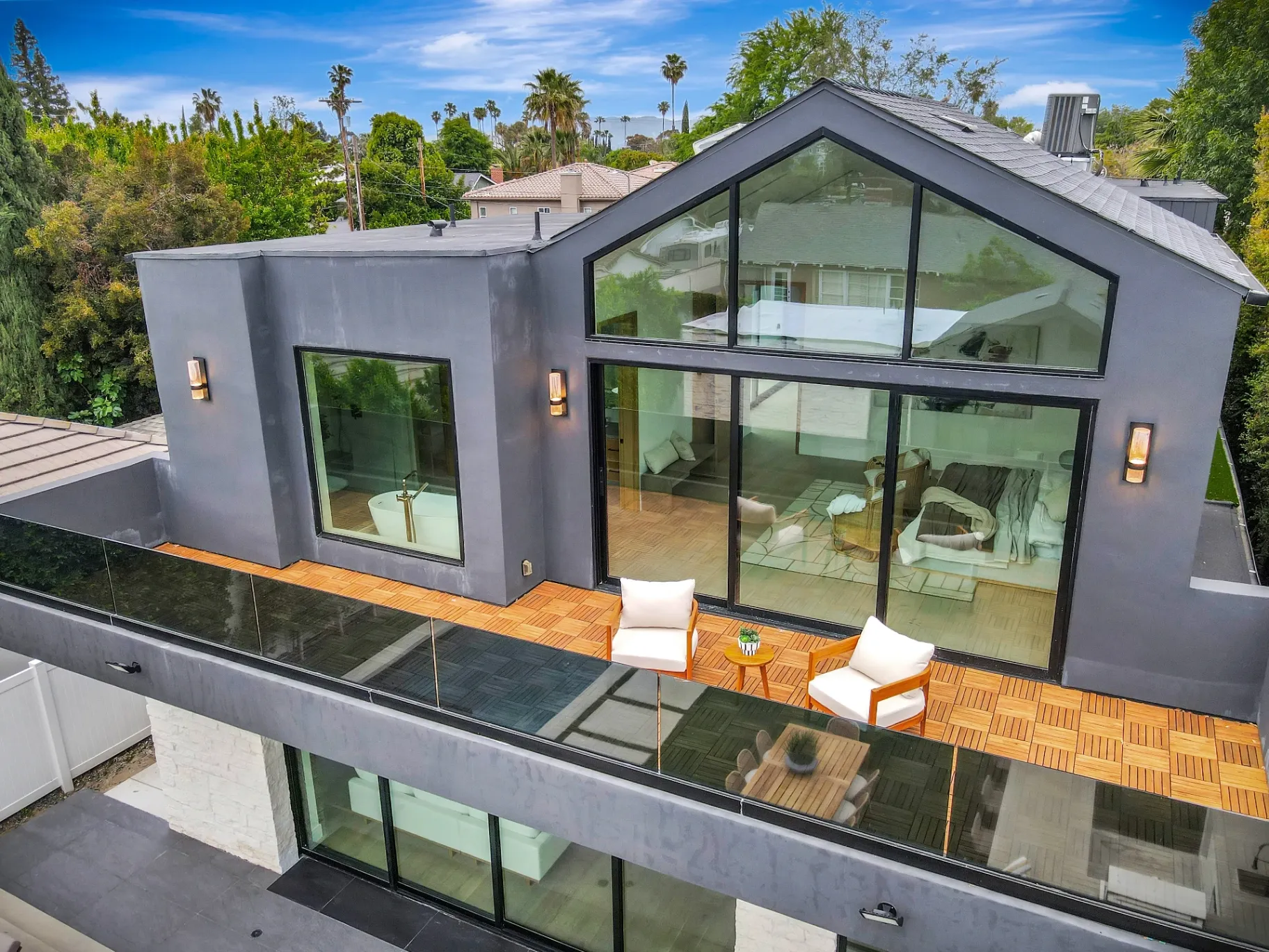 15602 Morrison St — Exterior: 15602 Morrison St — Contemporary home exterior with expansive glass windows, modern deck, and seamless indoor-outdoor living design