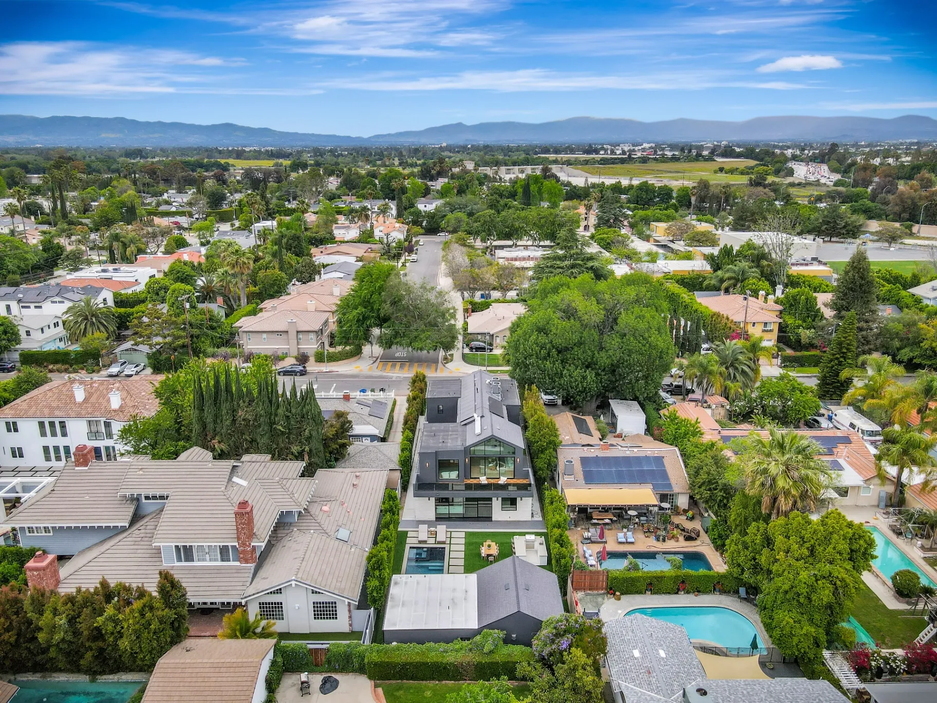 15602 Morrison St — Exterior: 15602 Morrison St — Aerial view of modern home in Sherman Oaks neighborhood with mountain backdrop and contemporary residential design