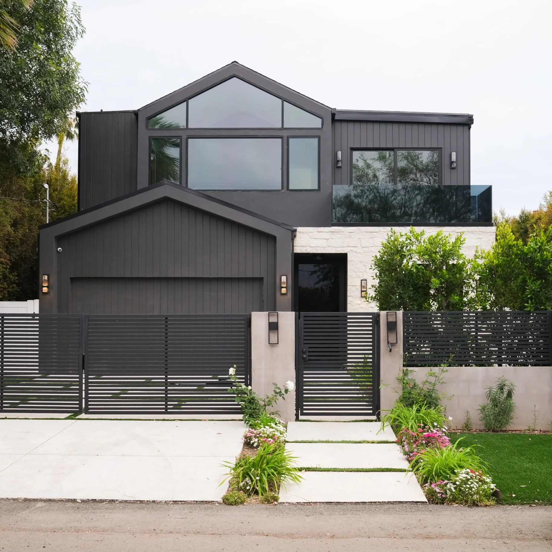 15602 Morrison St — Exterior: 15602 Morrison St — Street-facing exterior with horizontal-slat privacy fencing, modern garage design, and professionally landscaped entrance