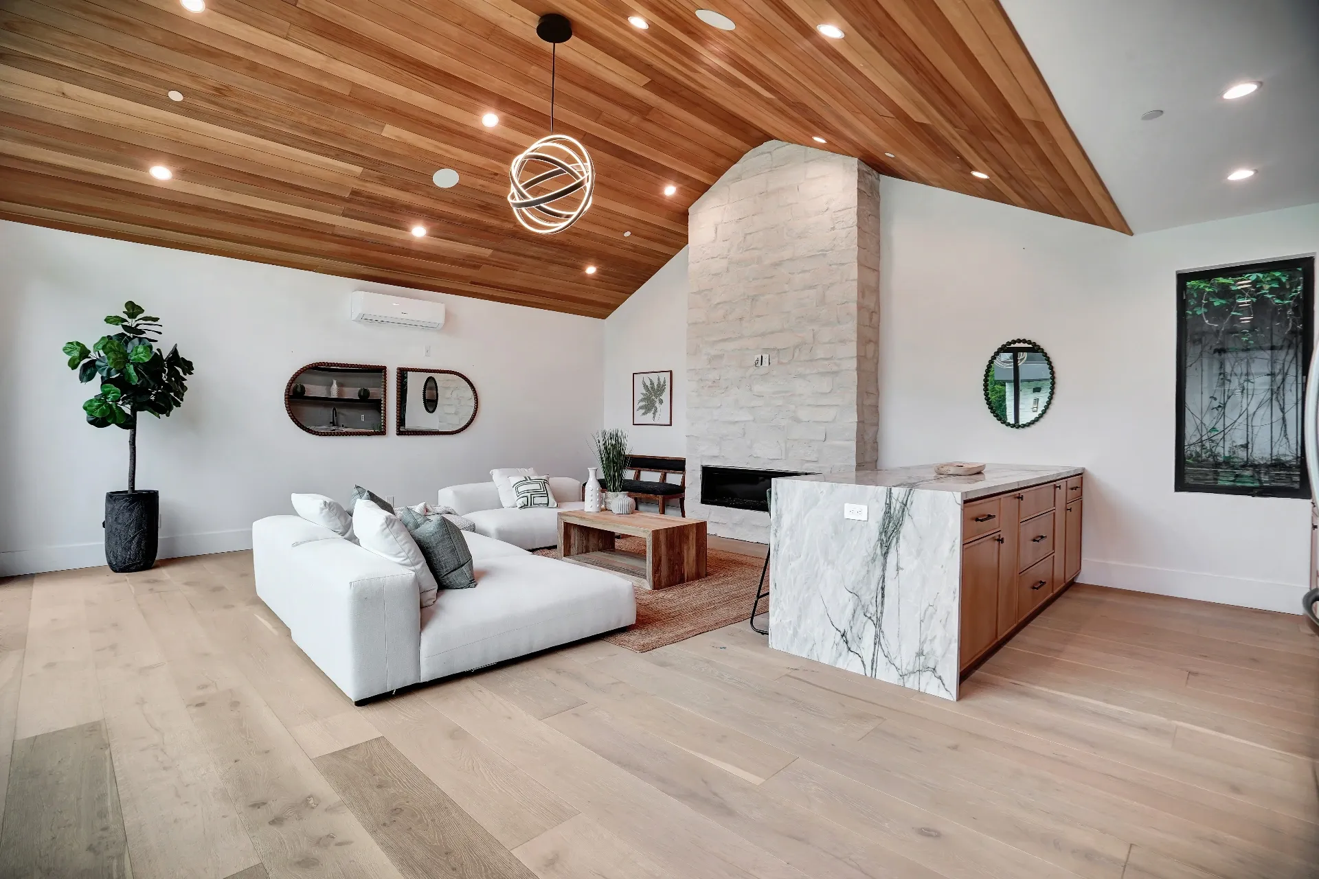 15602 Morrison St — Guest House: 15602 Morrison St — Guest house living room with wood ceiling, white sectional sofa, marble fireplace, and contemporary furnishings
