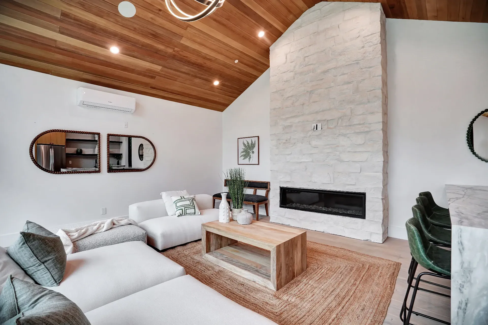 15602 Morrison St — Guest House: 15602 Morrison St — Guest house living area featuring modern fireplace, wood beam ceiling, and elegant white seating arrangement