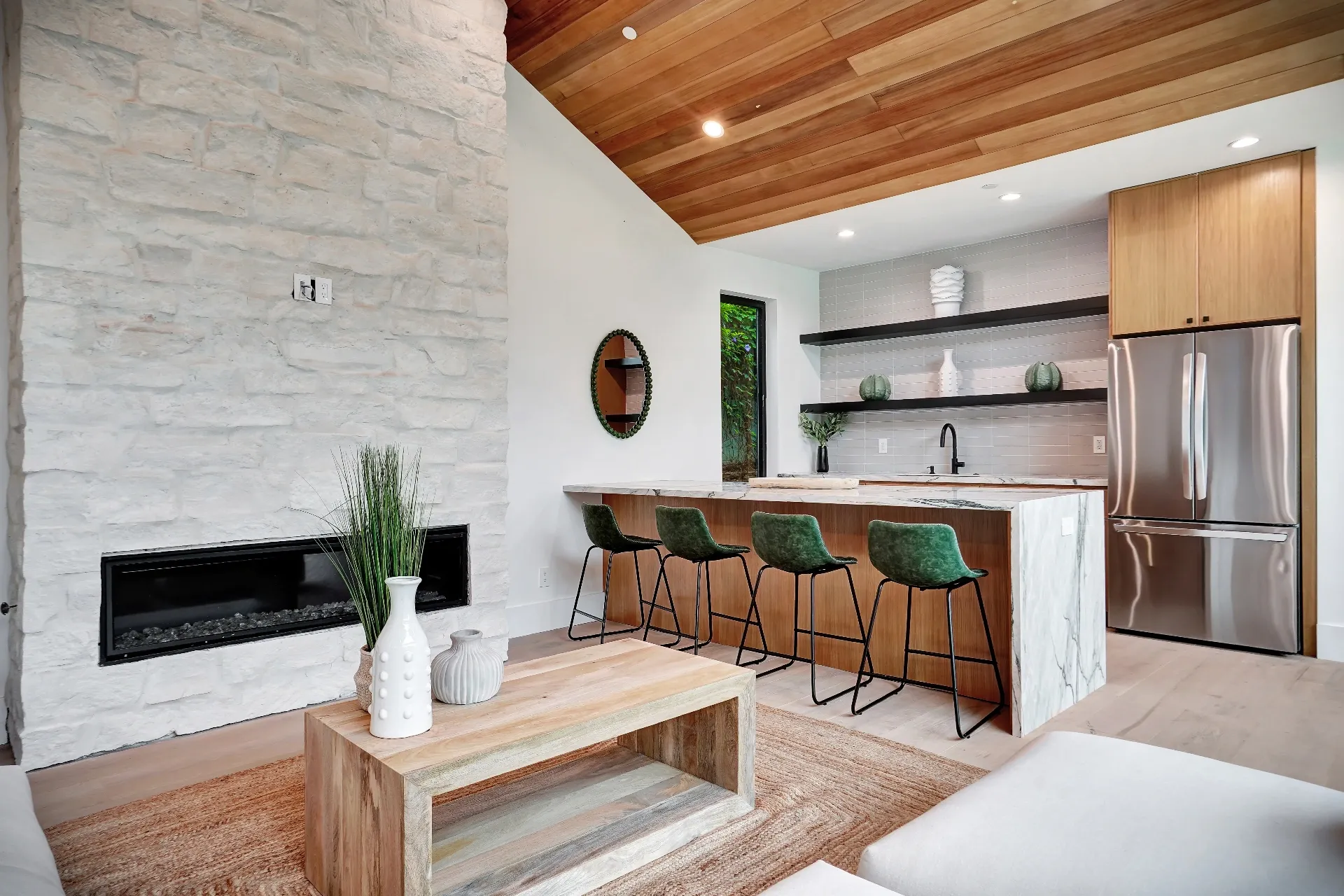 15602 Morrison St — Guest House: 15602 Morrison St — Guest house kitchen with green velvet bar stools, marble waterfall island, and modern appliances