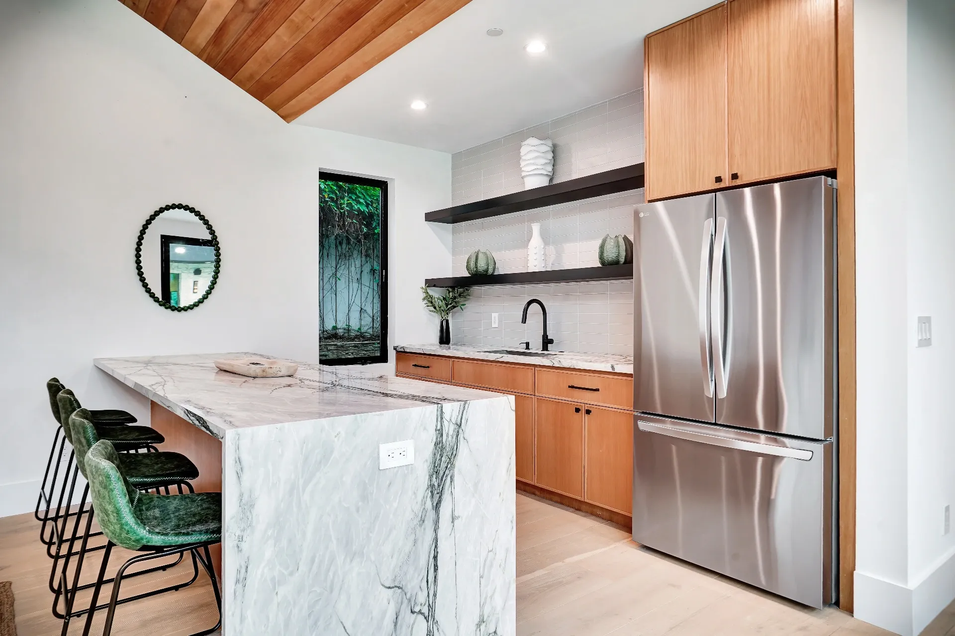 15602 Morrison St — Guest House: 15602 Morrison St — Guest house kitchen featuring marble waterfall island, wood cabinets, and stainless steel appliances