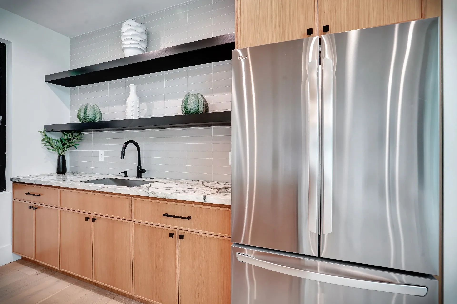 15602 Morrison St — Guest House: 15602 Morrison St — Guest house kitchen showcasing wood cabinetry, marble counters, and premium stainless appliances