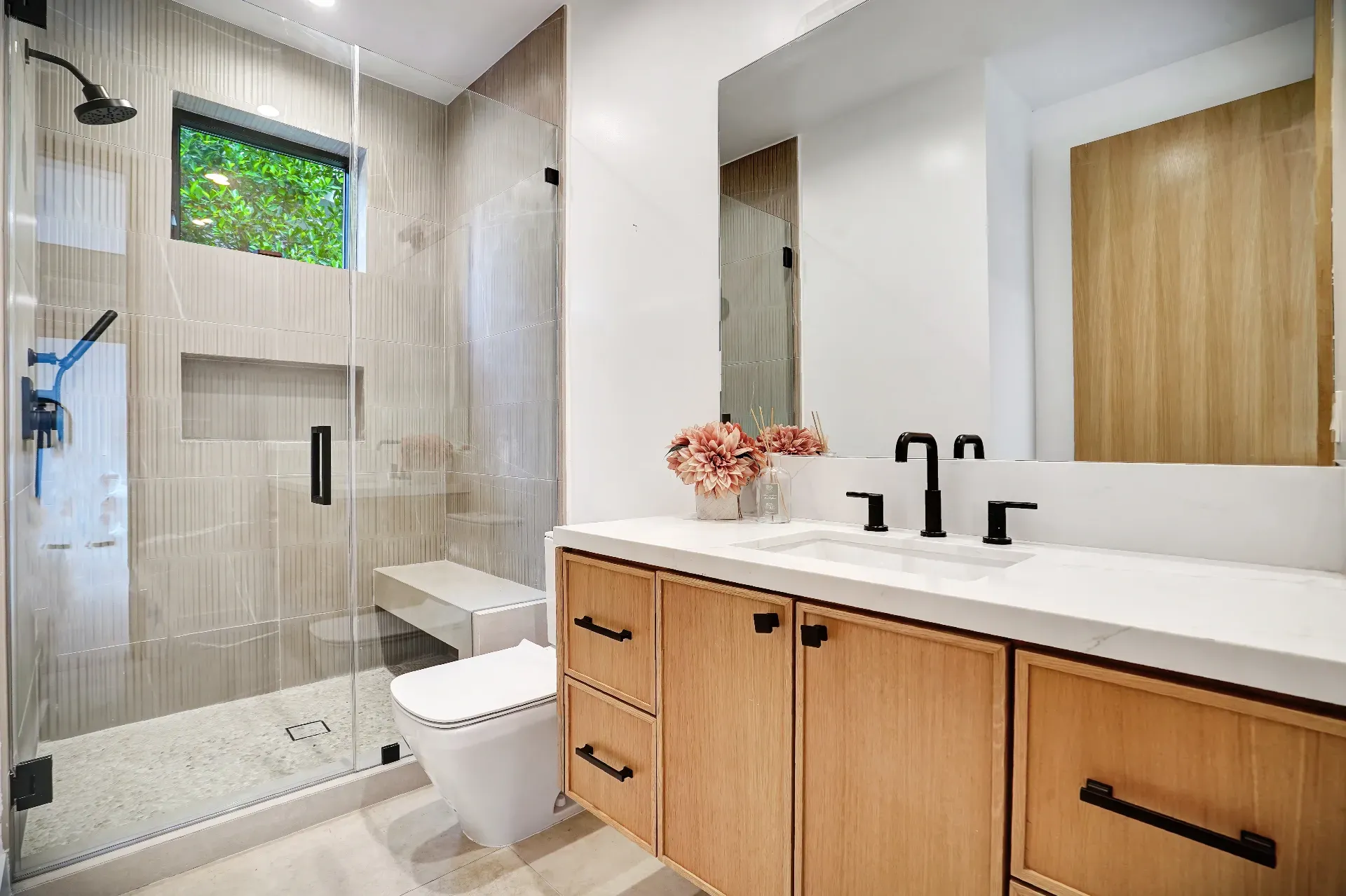 15602 Morrison St — Guest House: 15602 Morrison St — Guest house bathroom with glass walk-in shower, wood vanity, white quartz countertops, and contemporary fixtures
