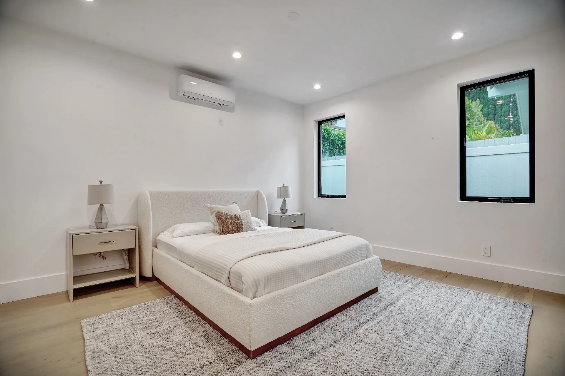 15602 Morrison St — Guest House: 15602 Morrison St — Guest house bedroom with modern platform bed, neutral bedding, and minimalist contemporary design