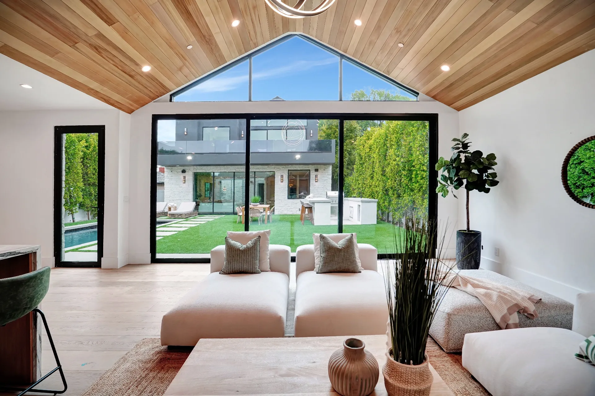 15602 Morrison St — Guest House: 15602 Morrison St — Guest house great room with vaulted wood ceiling, floor-to-ceiling windows, and modern living furniture