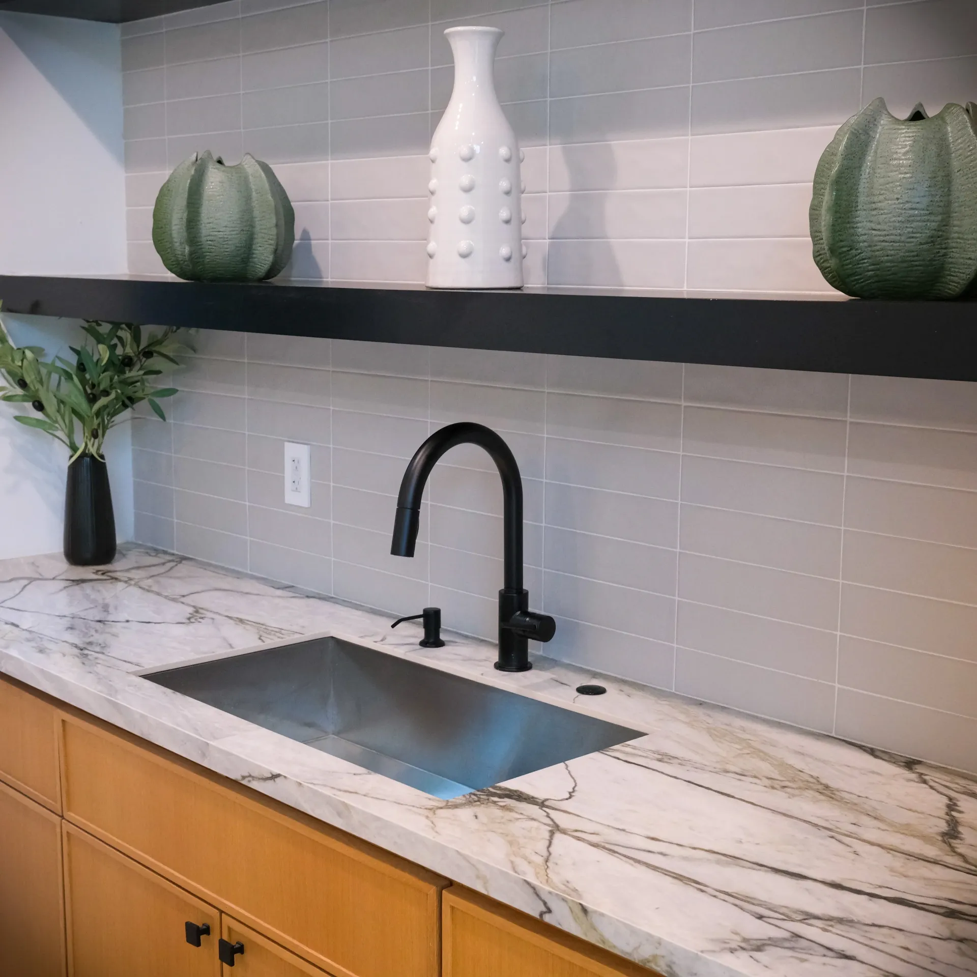 15602 Morrison St — Guest House: 15602 Morrison St — Guest house kitchen detail with marble countertops, undermount sink, black matte faucet, and contemporary styling