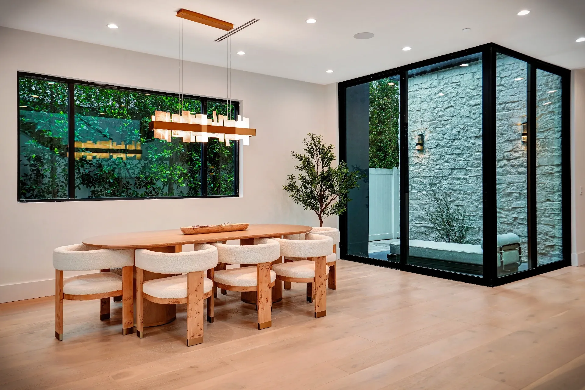 15602 Morrison St — Kitchen: 15602 Morrison St — Dining area with round wood table, cane-back chairs, pendant lighting, and outdoor courtyard views