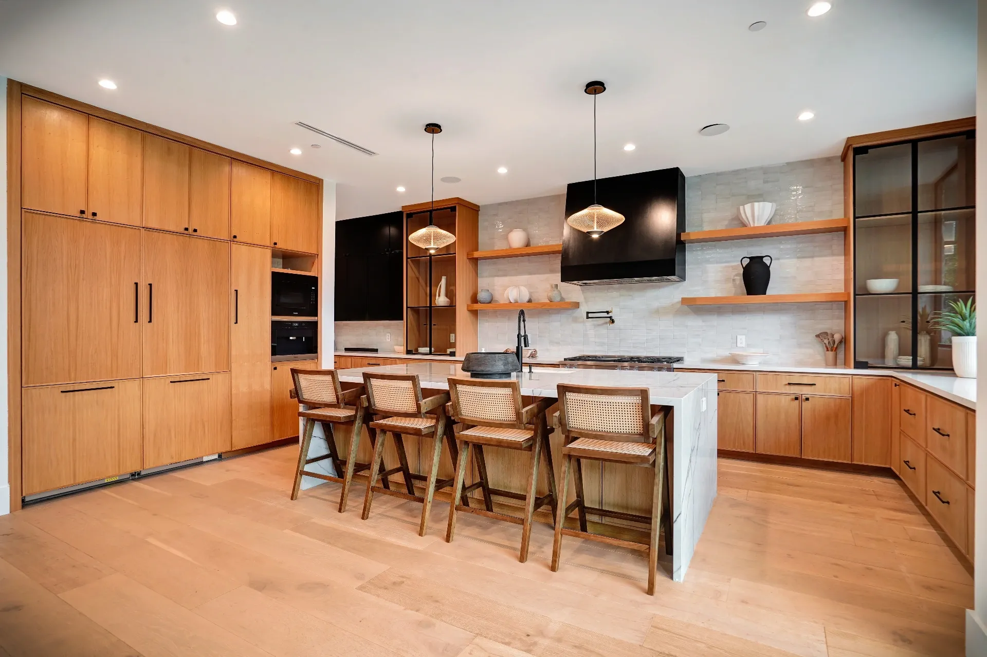 15602 Morrison St — Kitchen: 15602 Morrison St — Contemporary kitchen featuring wood cabinets, marble island, premium appliances, and modern pendant lights