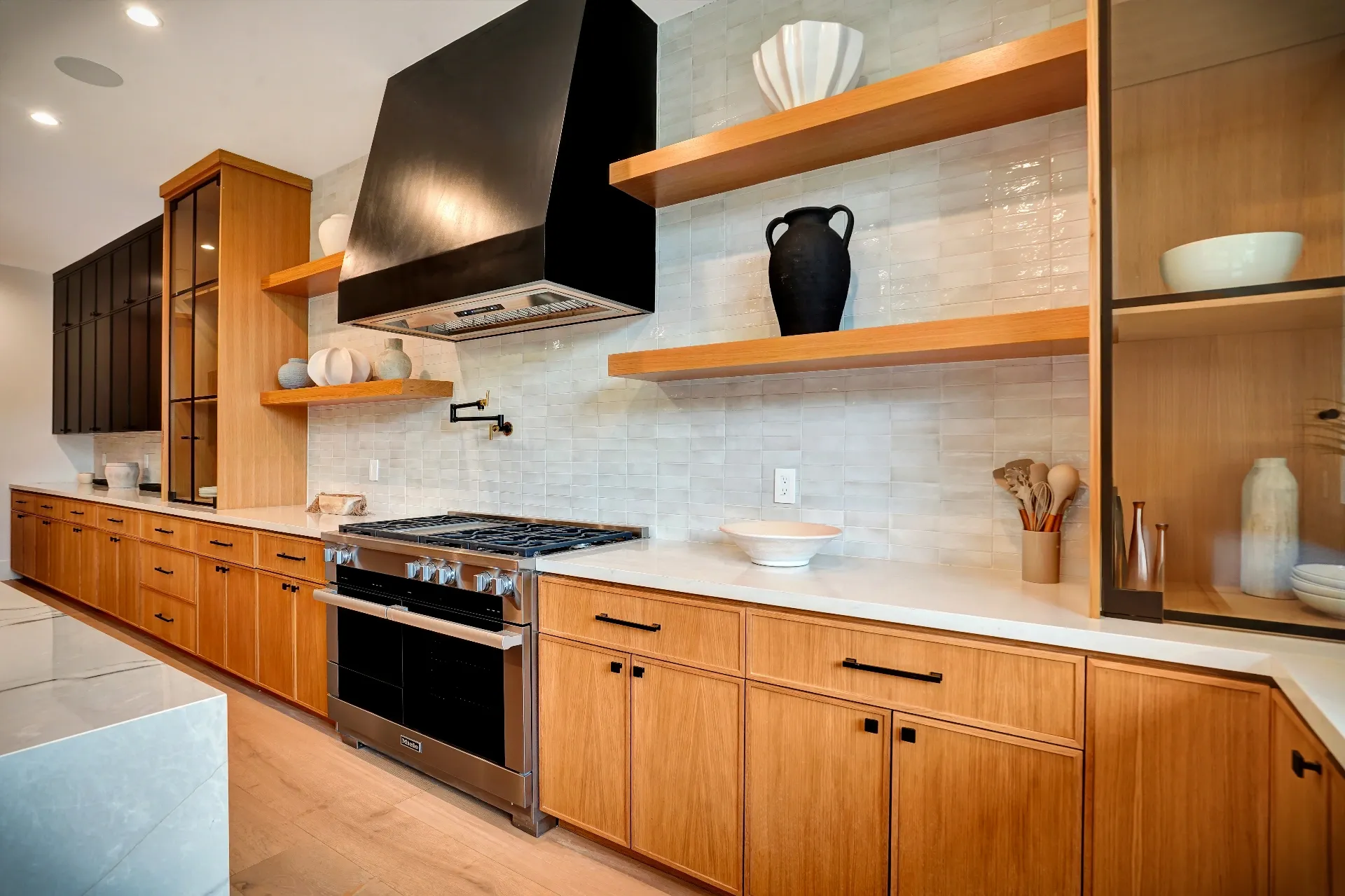 15602 Morrison St — Kitchen: 15602 Morrison St — Kitchen detail showing wood cabinetry, marble backsplash, floating shelves, and professional-grade appliances