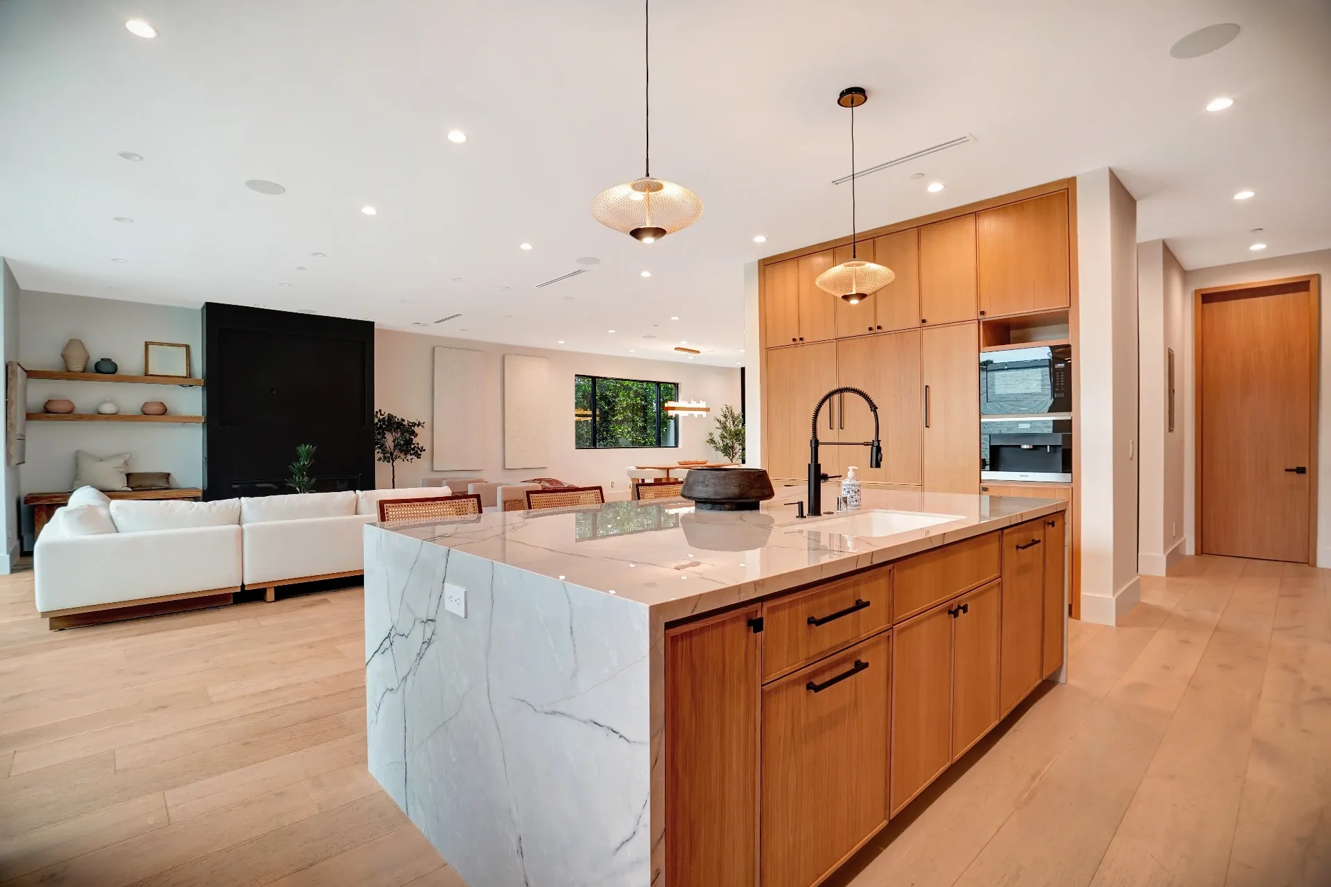 15602 Morrison St — Kitchen: 15602 Morrison St — Open concept kitchen with marble waterfall island, wood cabinetry, and seamless connection to living area