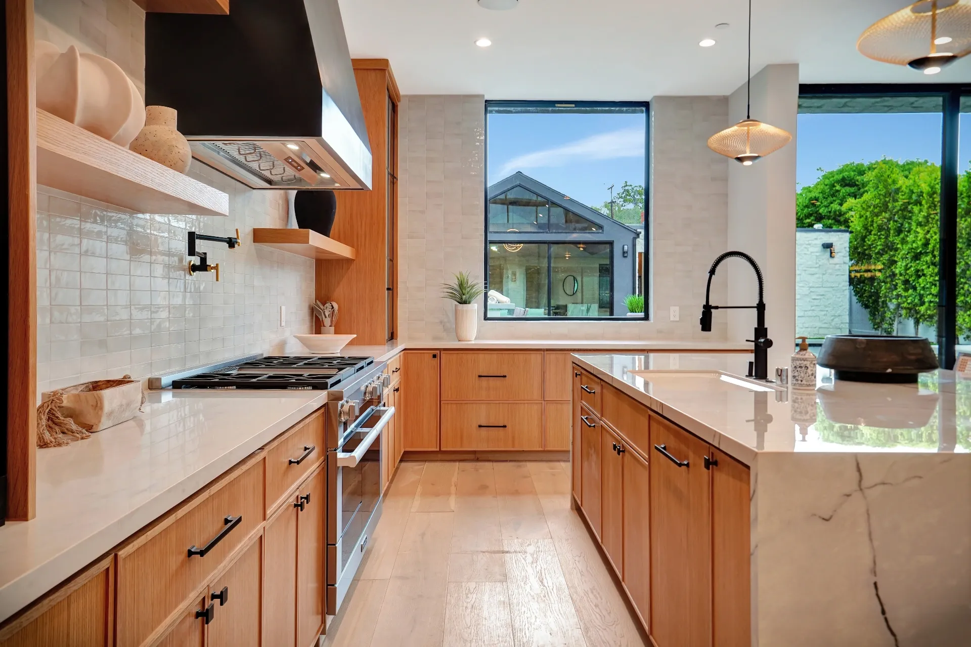 15602 Morrison St — Kitchen: 15602 Morrison St — Kitchen corner with wood cabinets, marble countertops, professional appliances, and garden views