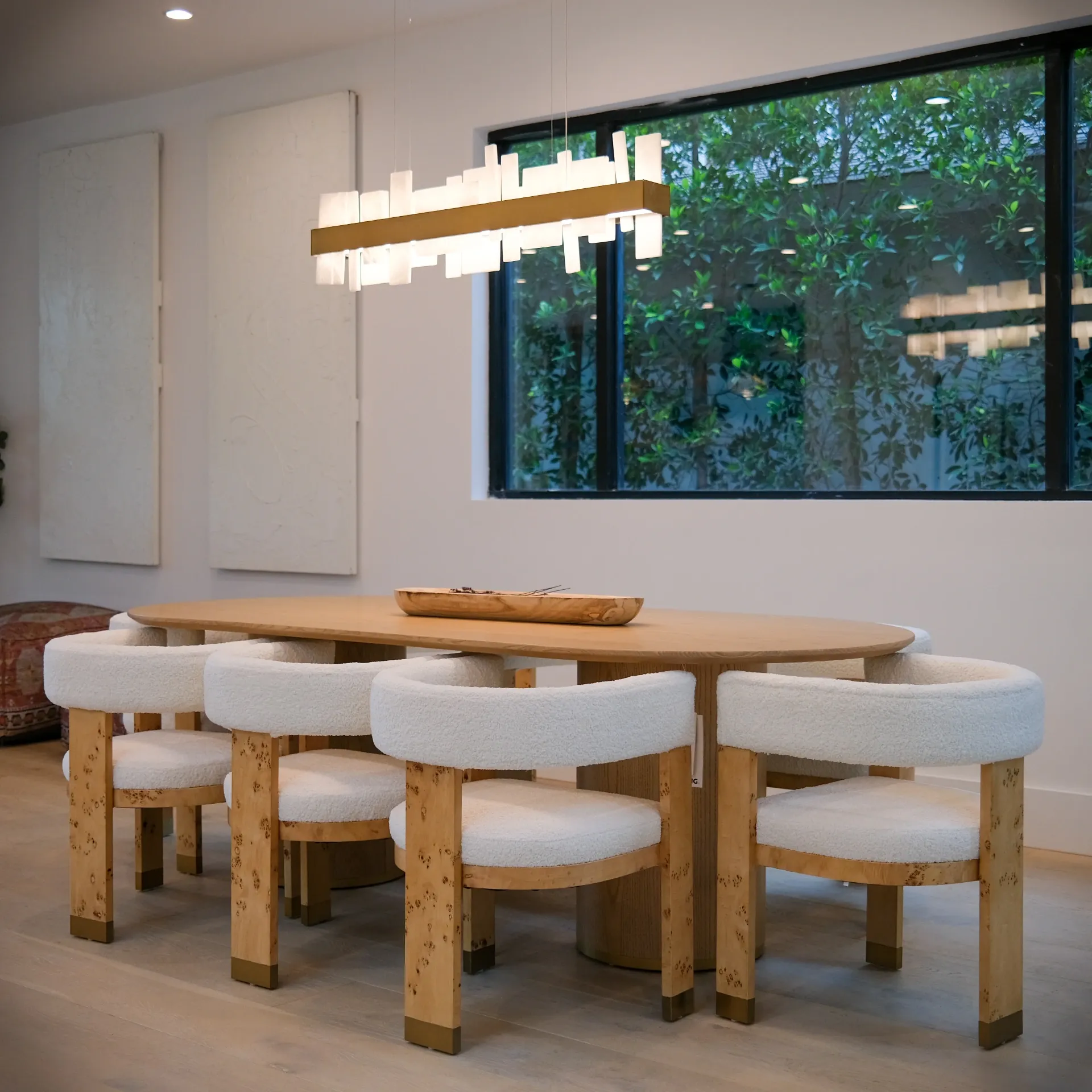15602 Morrison St — Kitchen: 15602 Morrison St — Dining room featuring oval wood table, cream chairs, linear pendant lighting, and floor-to-ceiling windows