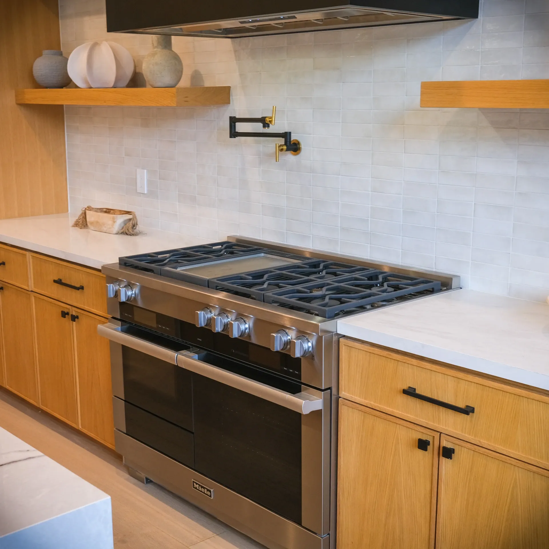 15602 Morrison St — Kitchen: 15602 Morrison St — Kitchen cooking station with professional range, wood cabinetry, marble countertops, and decorative pottery