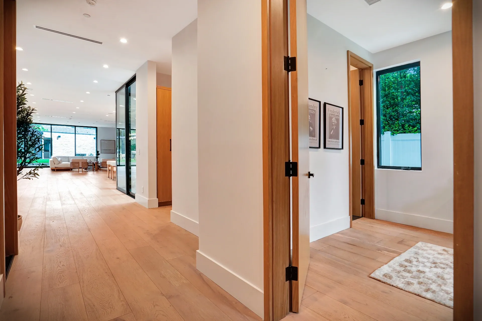 15602 Morrison St — Living Areas: 15602 Morrison St — Modern entry hallway with wood doors, wide-plank flooring, and clean contemporary architecture