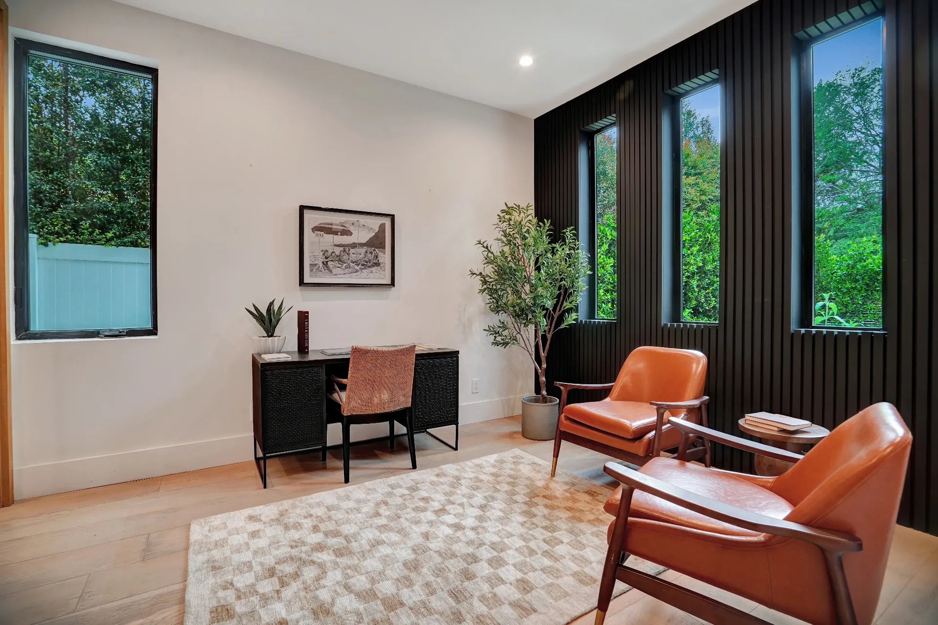 15602 Morrison St — Living Areas: 15602 Morrison St — Home office with orange mid-century modern chairs, black desk, and floor-to-ceiling windows with garden views