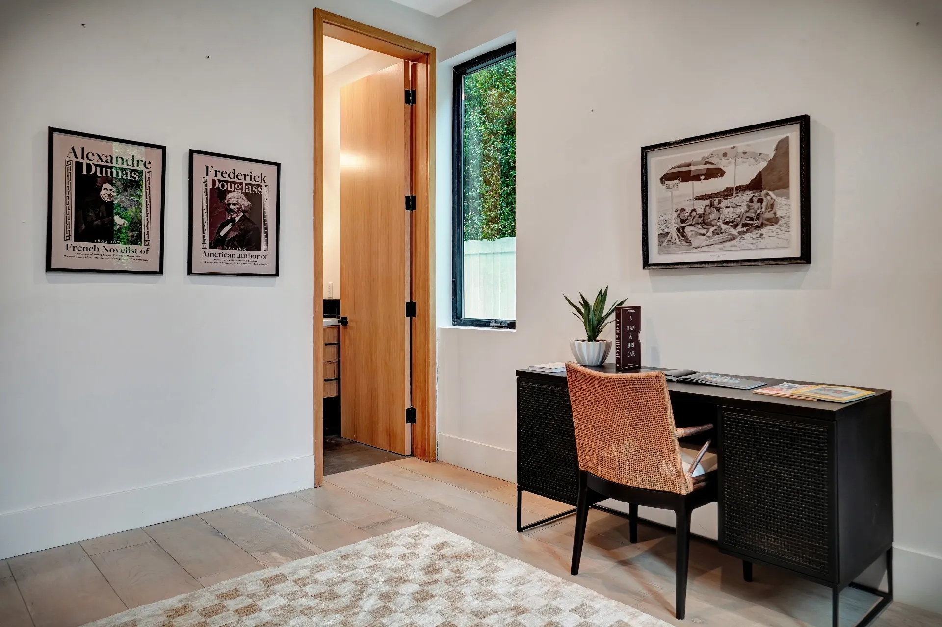 15602 Morrison St — Living Areas: 15602 Morrison St — Study area with vintage literary posters, modern black desk, and contemporary orange seating
