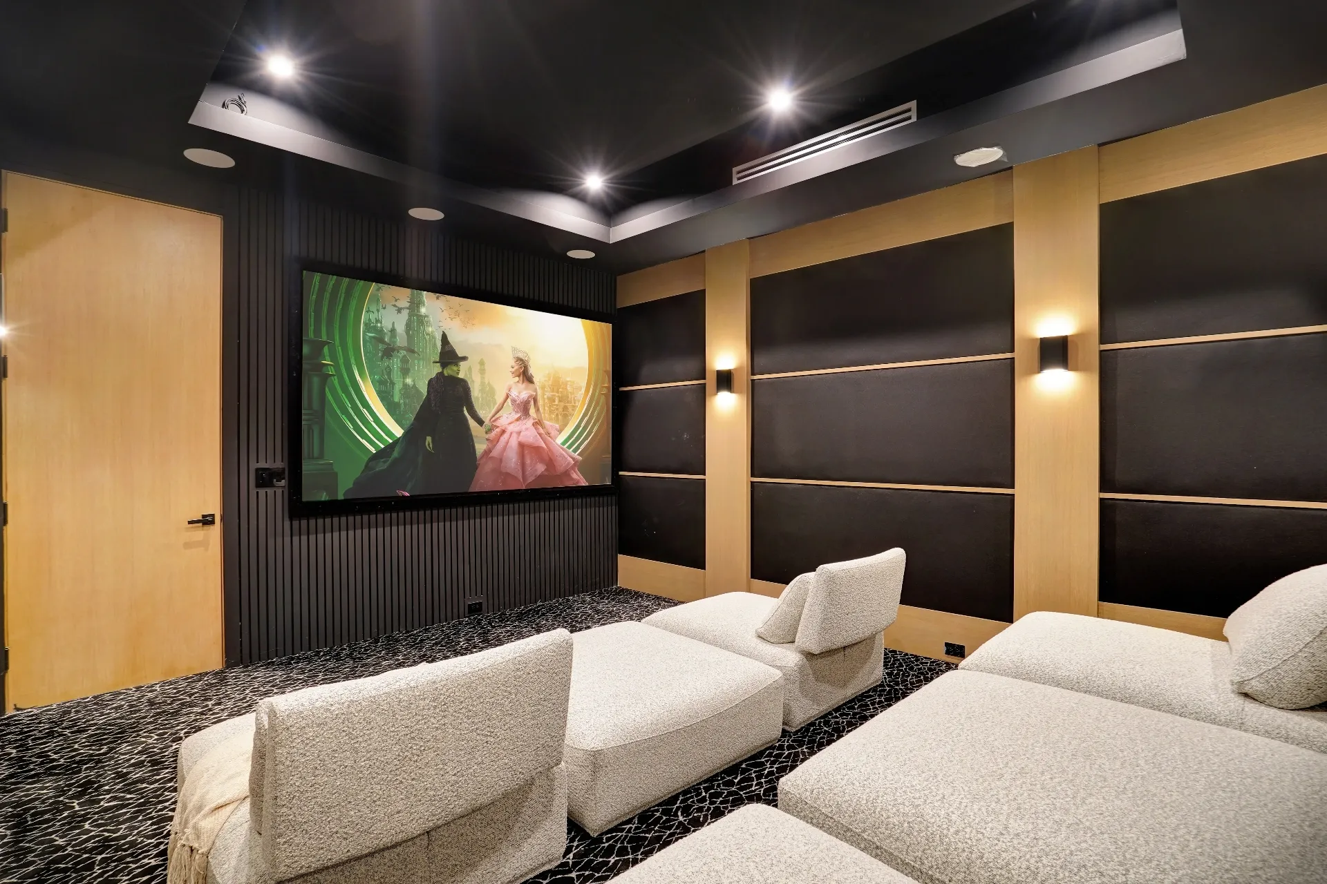 15602 Morrison St — Living Areas: 15602 Morrison St — Movie theater featuring large screen, custom acoustic panels, and plush white lounge seating
