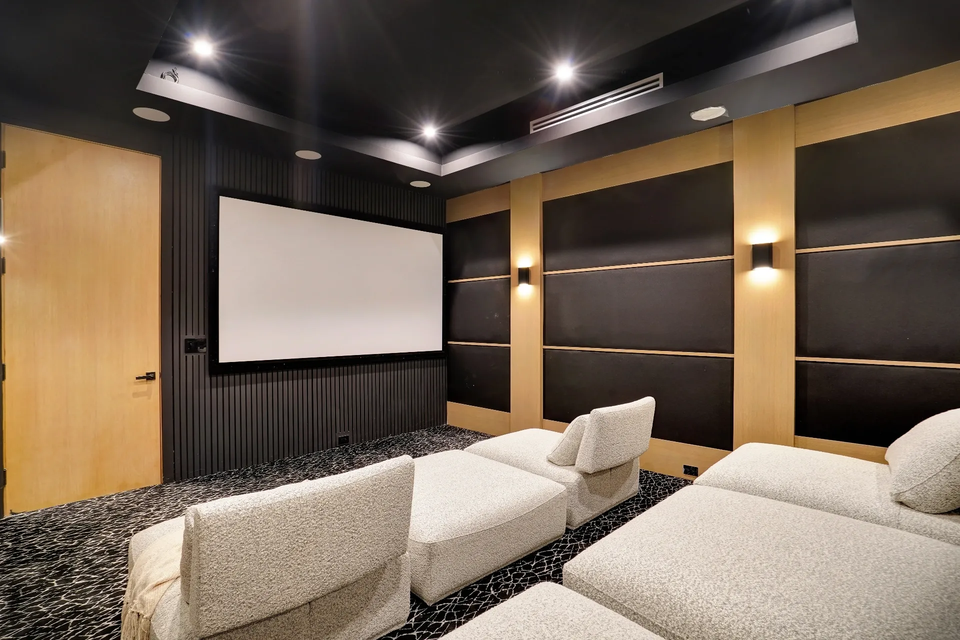 15602 Morrison St — Living Areas: 15602 Morrison St — Cinema room with projection screen, theatrical lighting, and contemporary white recliners