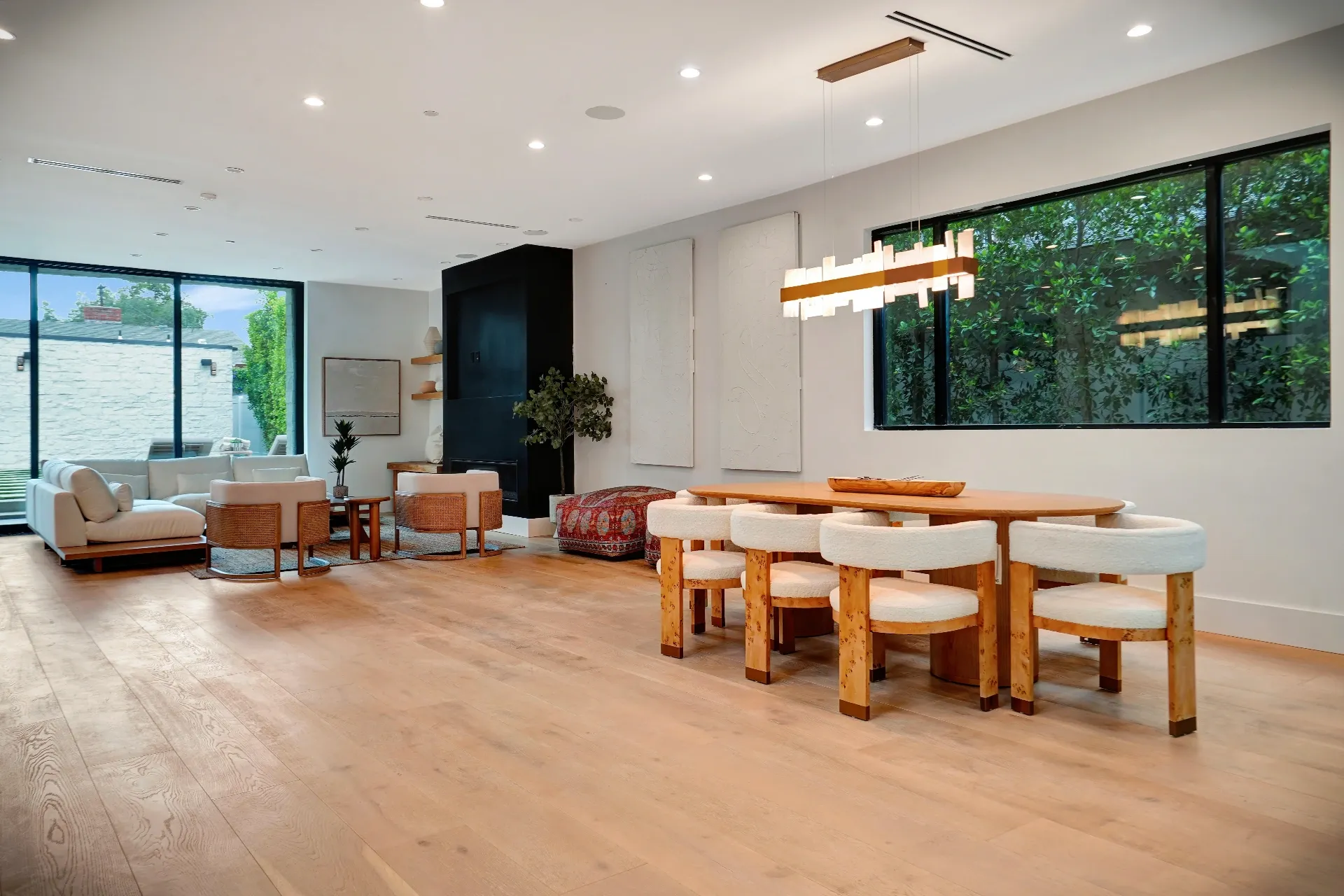 15602 Morrison St — Living Areas: 15602 Morrison St — Open concept living and dining with oval wood table, white upholstered chairs, and modern chandelier