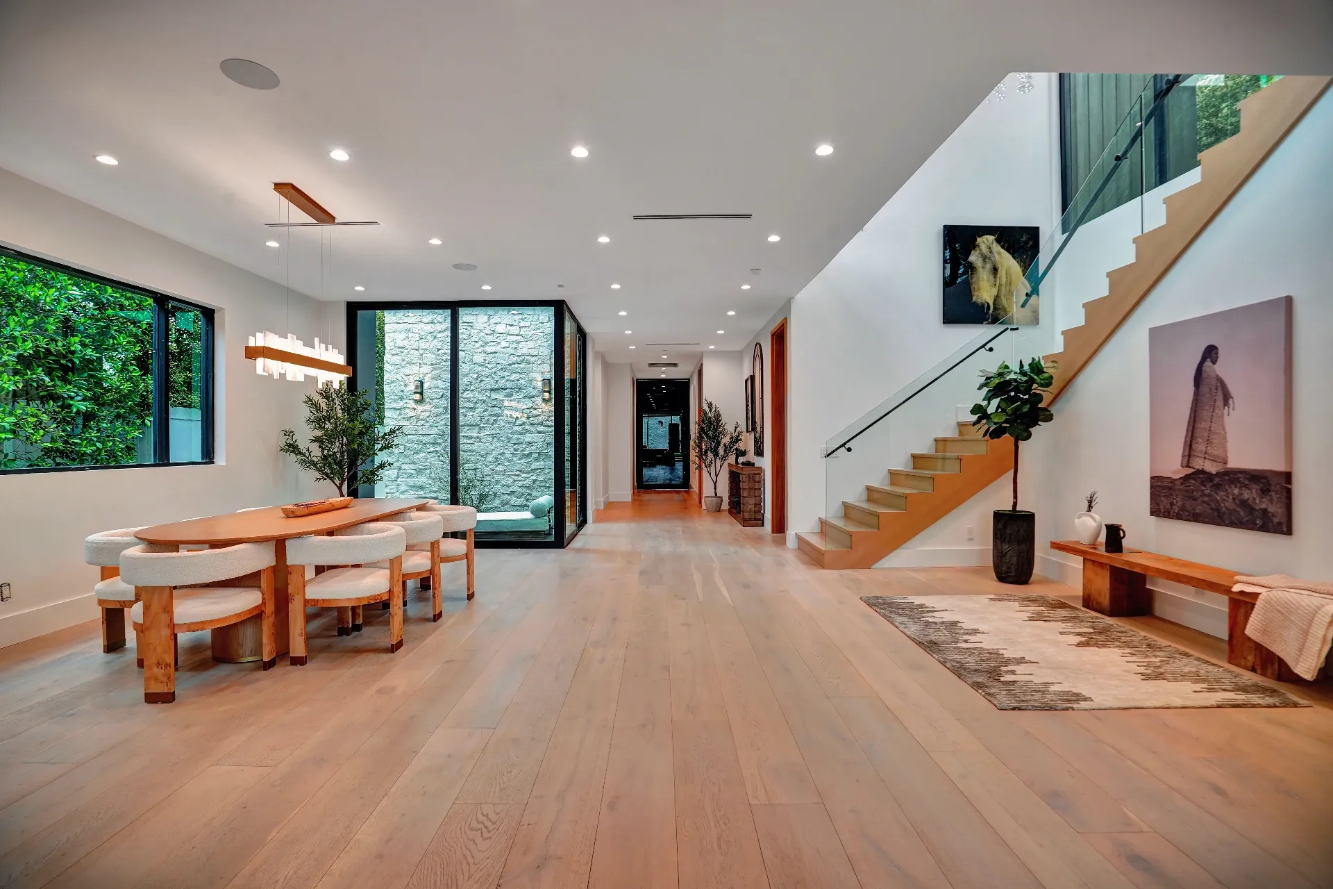 15602 Morrison St — Living Areas: 15602 Morrison St — Open concept living area with floating staircase, wood dining table, and seamless indoor-outdoor flow