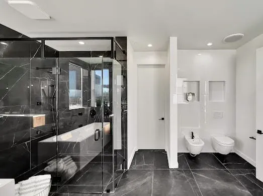 124 S Croft Ave — Bathrooms: Modern bathroom with black marble shower and glass enclosure