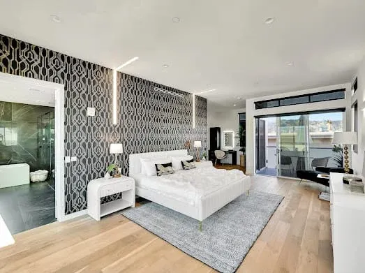124 S Croft Ave — Bedrooms: Primary suite with geometric accent wall and luxury white bedding