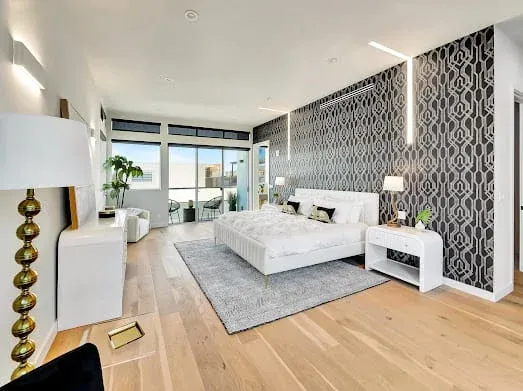 124 S Croft Ave — Bedrooms: Spacious bedroom with city views and modern seating area