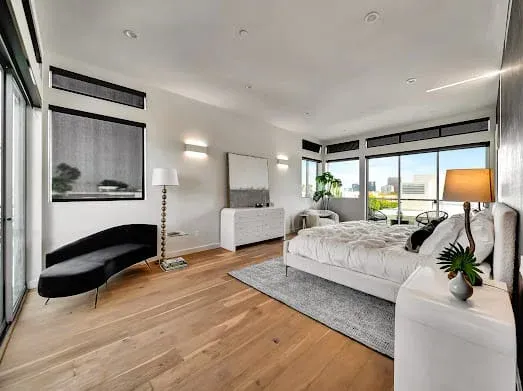 124 S Croft Ave — Bedrooms: Modern bedroom with wall-mounted TV and urban views